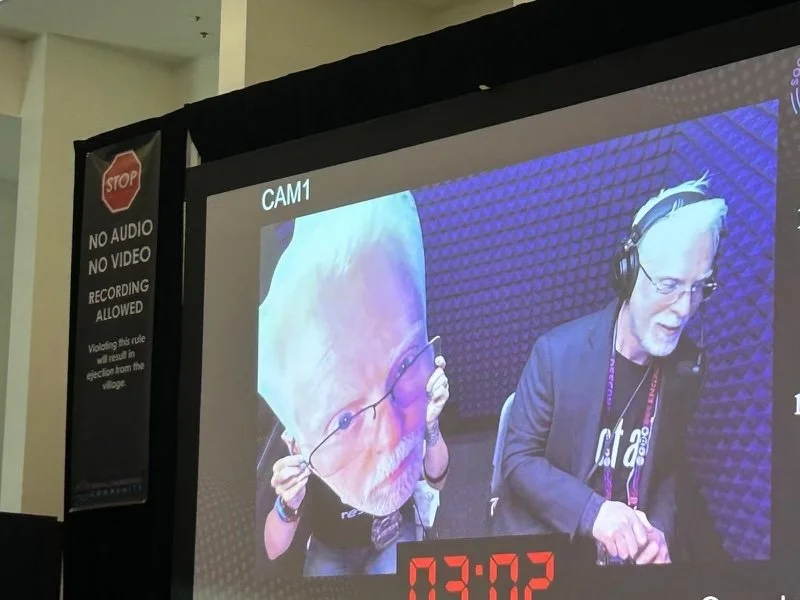 Perry Carpenter and Lisa Flynn in the booth at Defcon's Social Engineering Community Battle of the Bots competition, 2024.