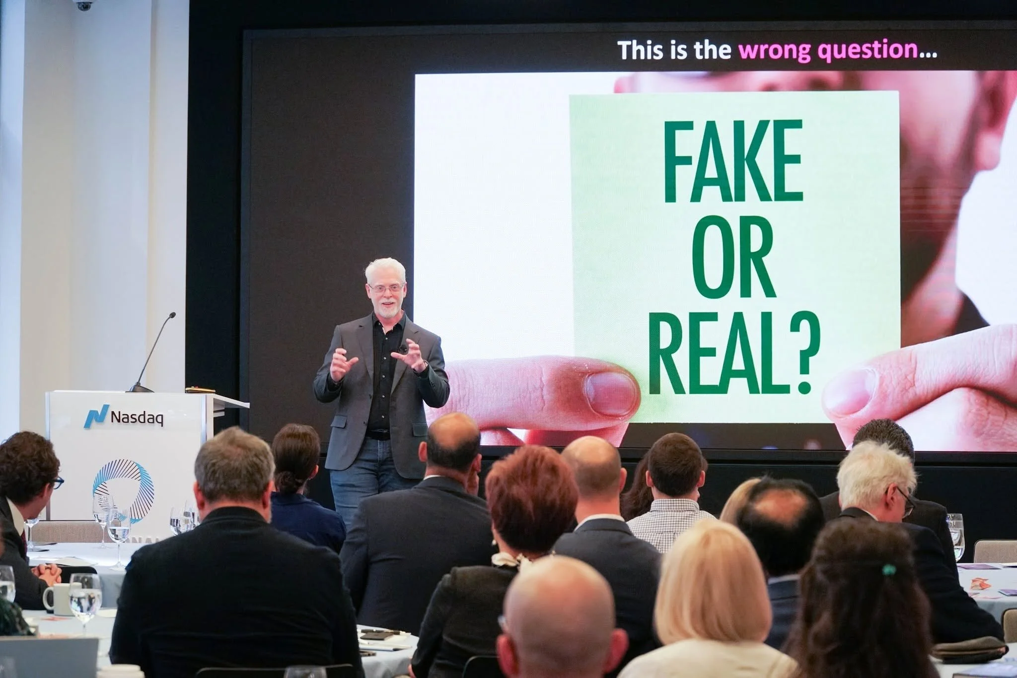 Perry Carpenter presenting at Nasdaq. The slide says 'FAKE OR REAL'...  'This is the wrong question...'