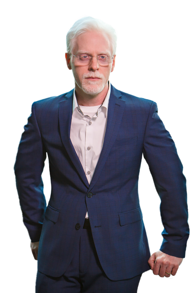 Perry Carpenter wearing a blue suit and white shirt. Transparent background.