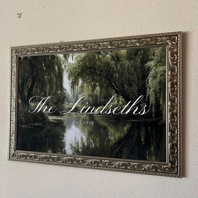 Framed wedding welcome sign featuring a romantic, painted nature scene of trees and a river, engraved with the family name "The Lindesths" and the establishment year "Est. 2026". Handmade by January Swift Studio.