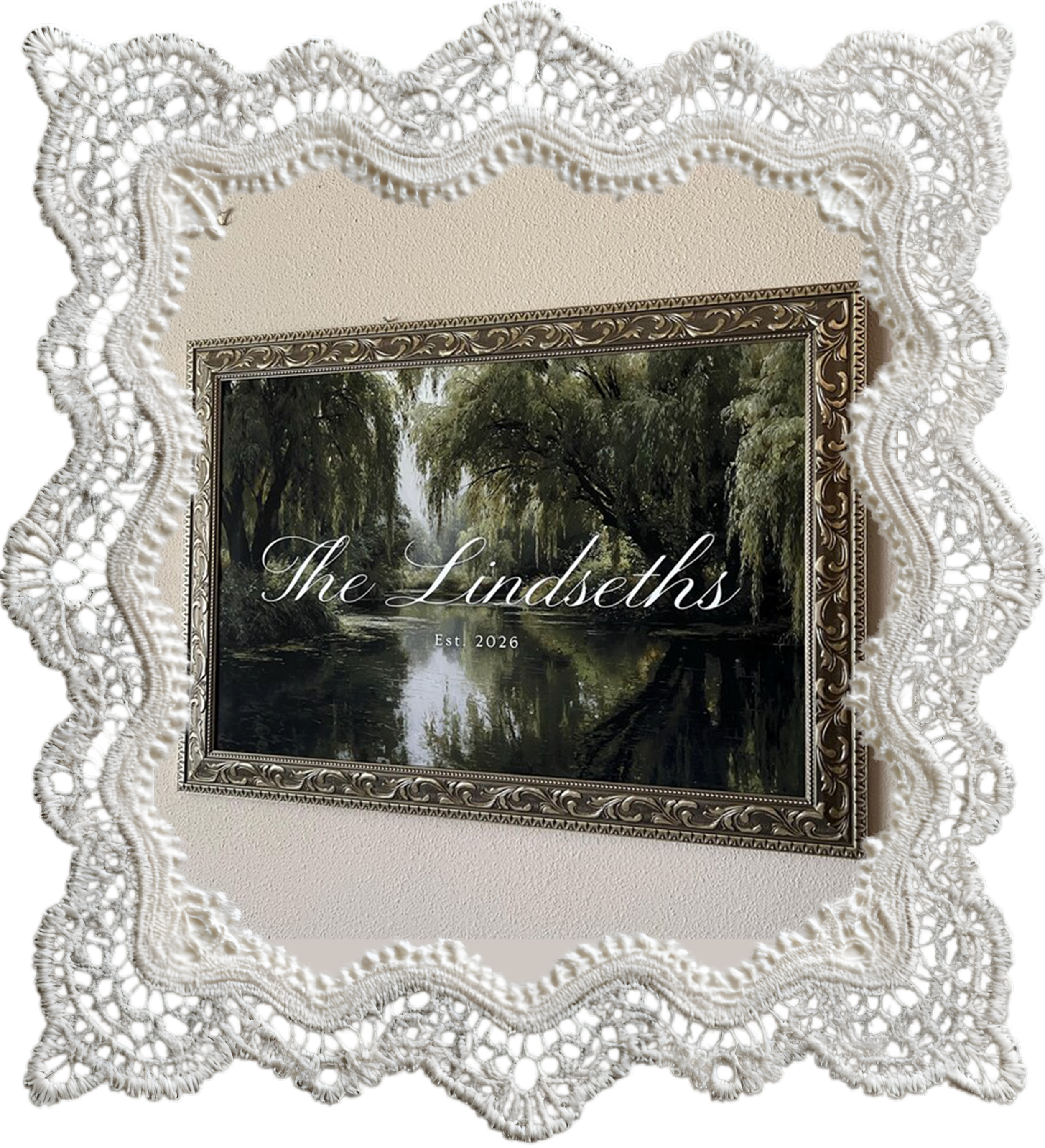 An ornate white lace frame surrounding a wedding welcome sign with artwork of tall trees over a waterway, with the text "The Lindseaths" and "Est. 2026" on the artwork.