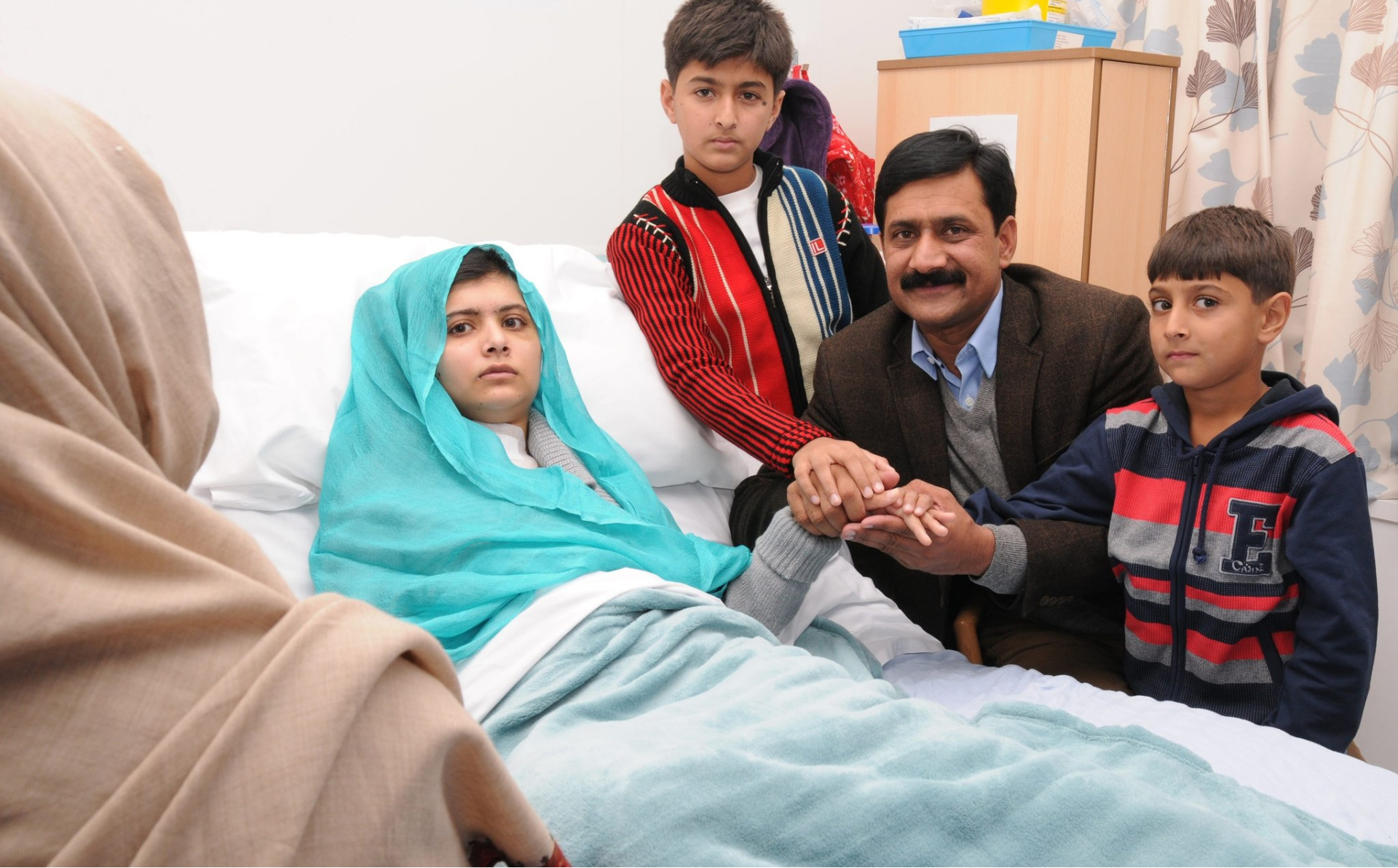 Khushal and his family at his sister's hospital bedside