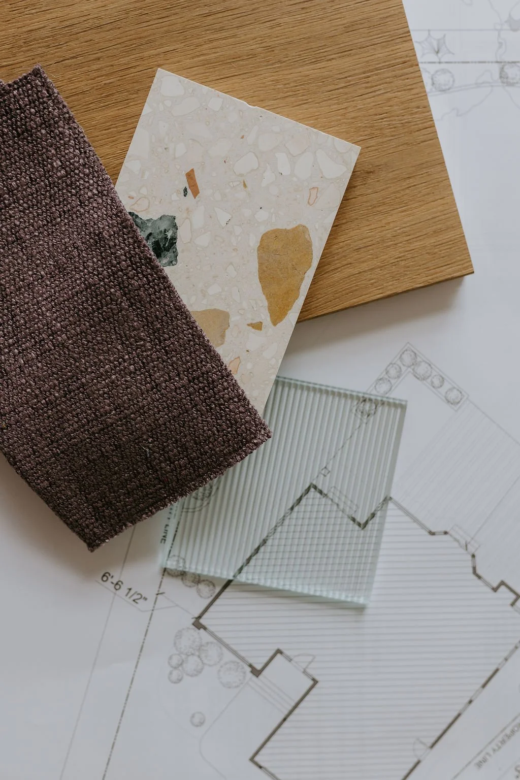 Interior design material samples and floor plans for a Vancouver renovation project.