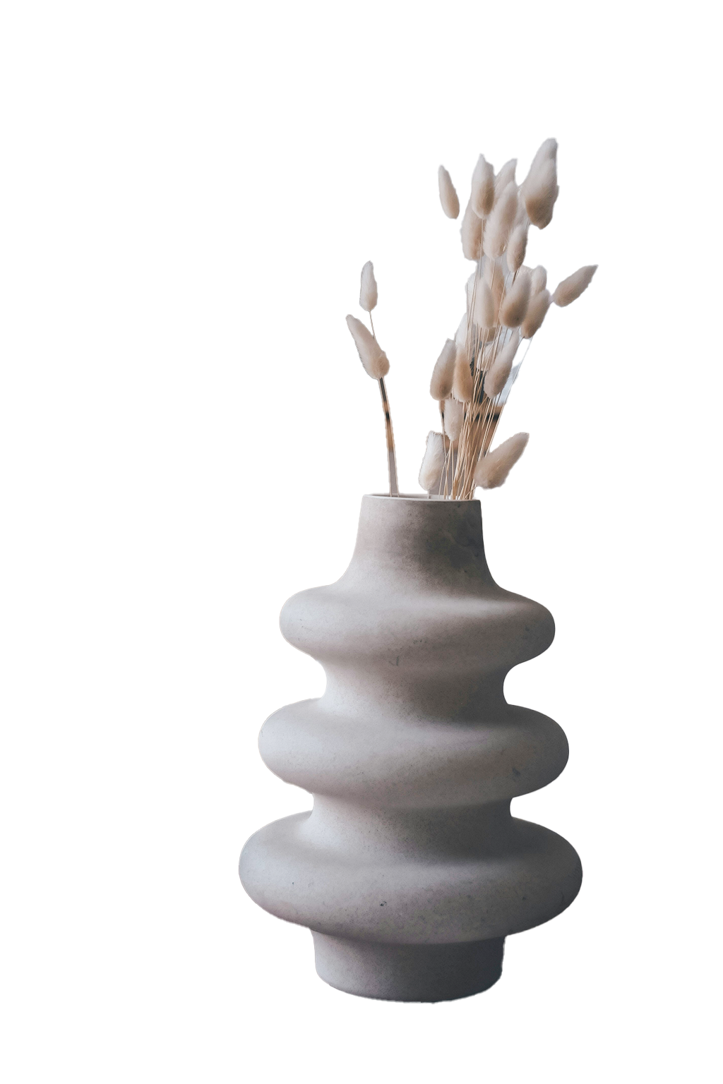 Sculptural vase with dried stems used as a natural interior styling detail.