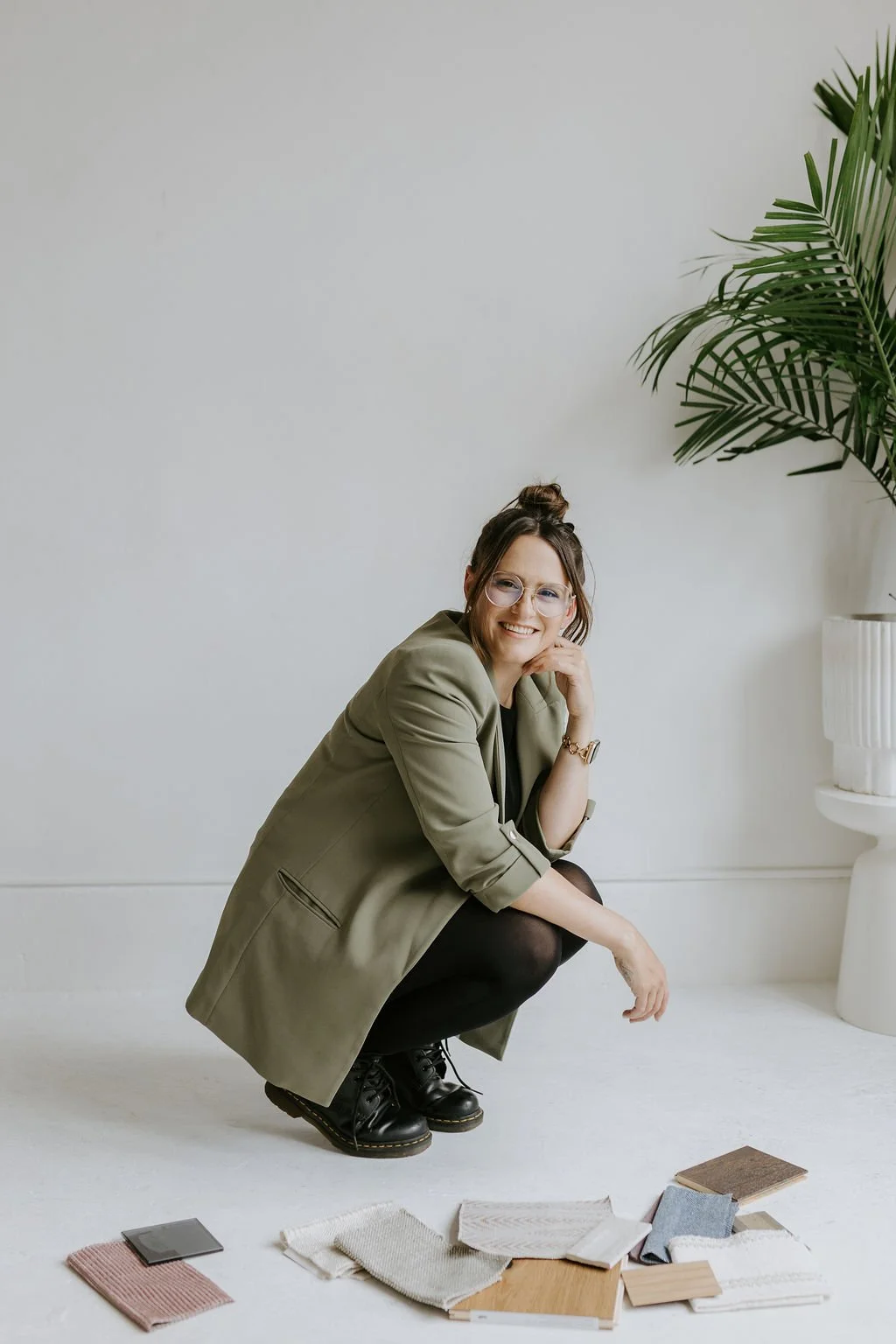 Alaina Gordon, founder of Pure Perspective, with interior design material samples in Vancouver.