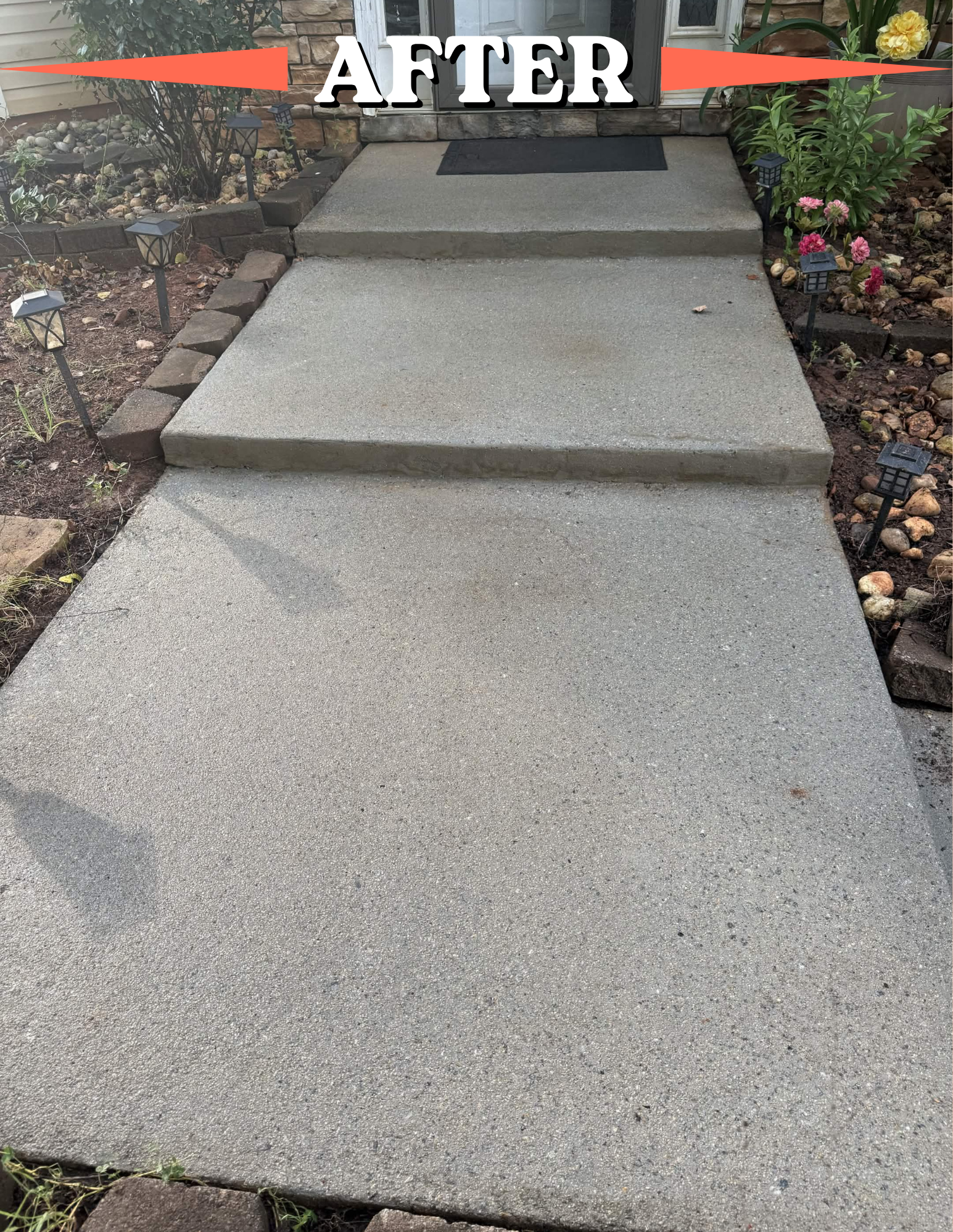 Newly poured concrete stairs and sidewalk leading to a house entrance, surrounded by small garden beds with plants, flowers, and decorative outdoor lights.