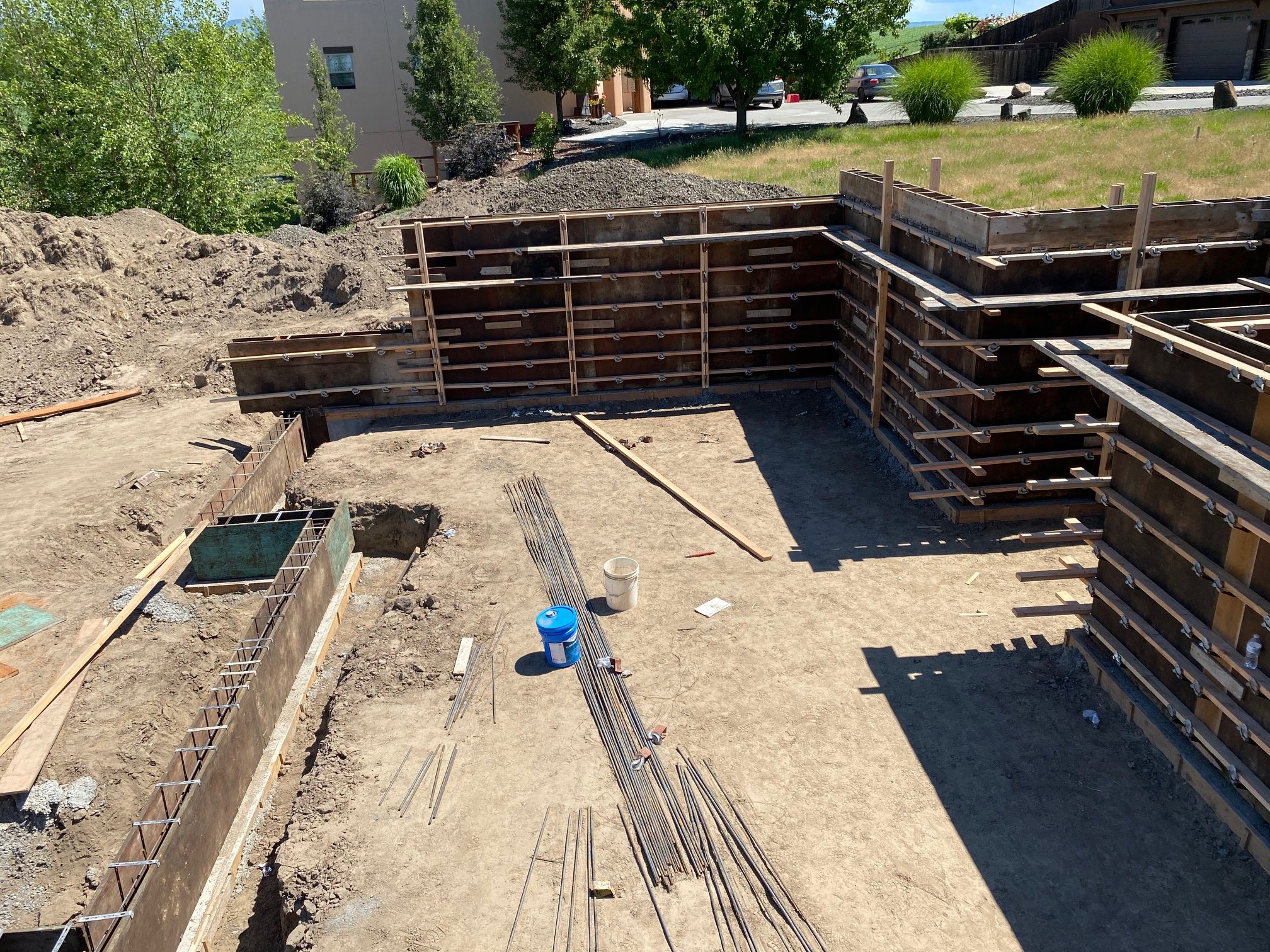 Construction site with concrete forms and rebar for building foundation.
