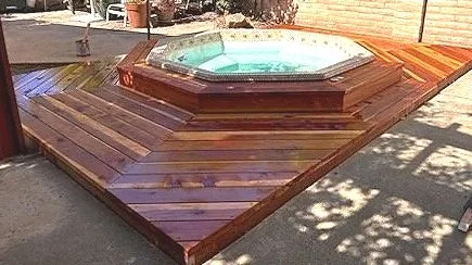 Redwood deck built around semi in-ground hot tub.