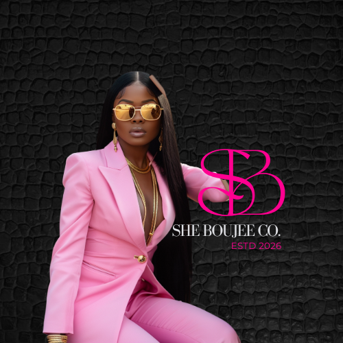 Professional woman with long black hair wearing a pink suit and gold sunglasses, sitting against a black textured background, with a logo for She Boujee Co.