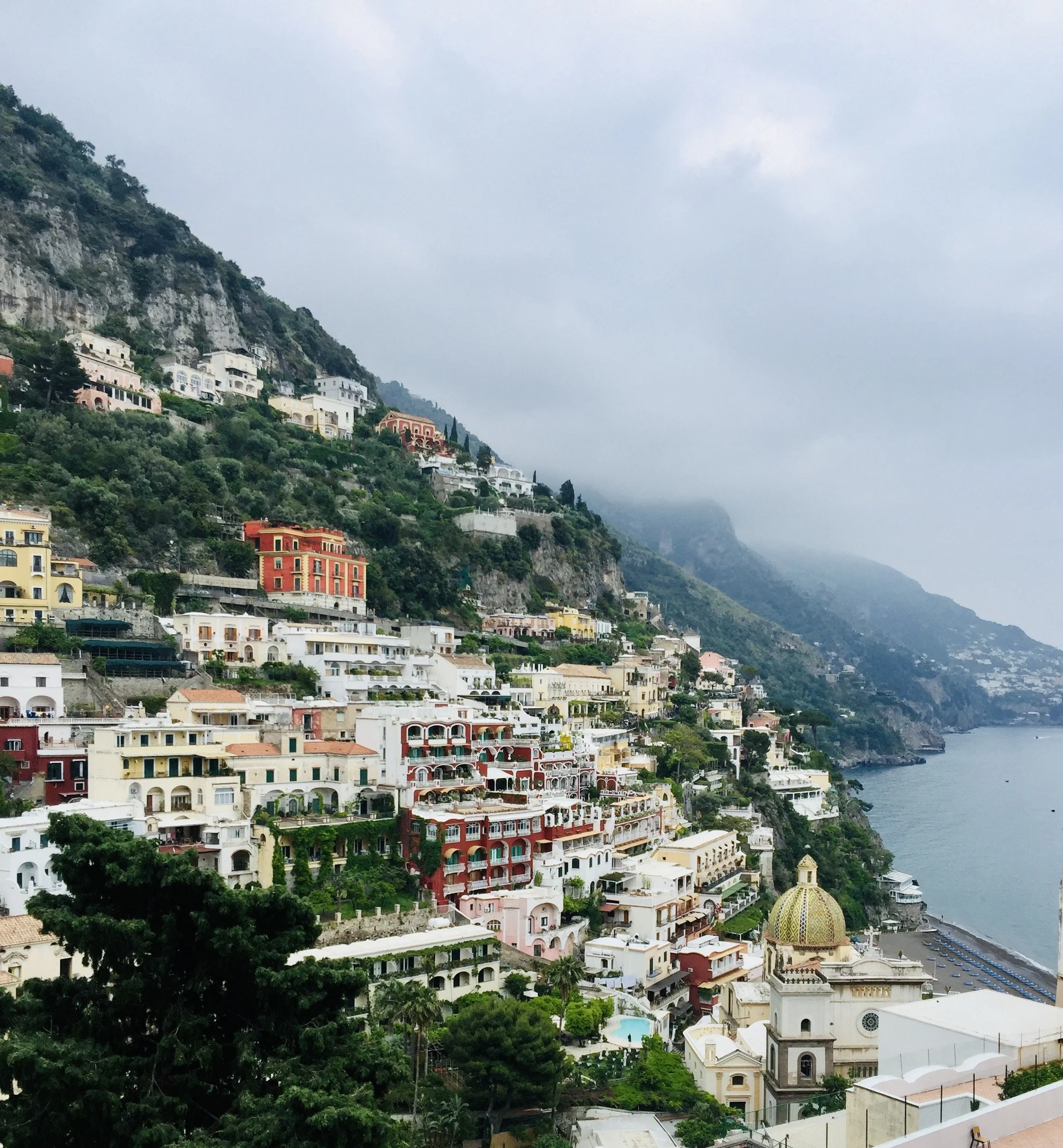 Colorful hillside buildings overlooking the Mediterranean Sea in Positano, Italy.