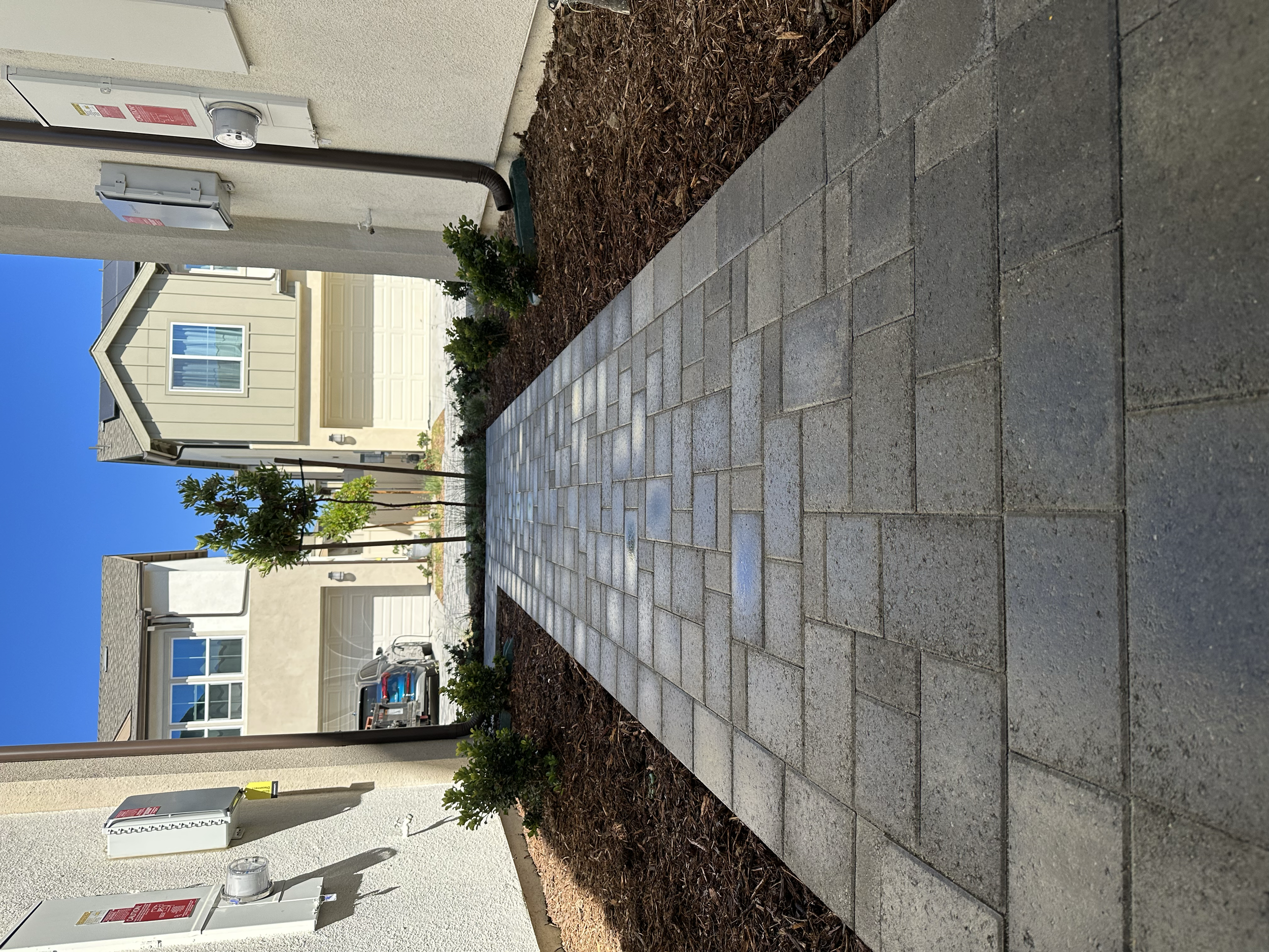 Paver walkway with landscape and mulch improvements for a clean, polished HOA community finish.