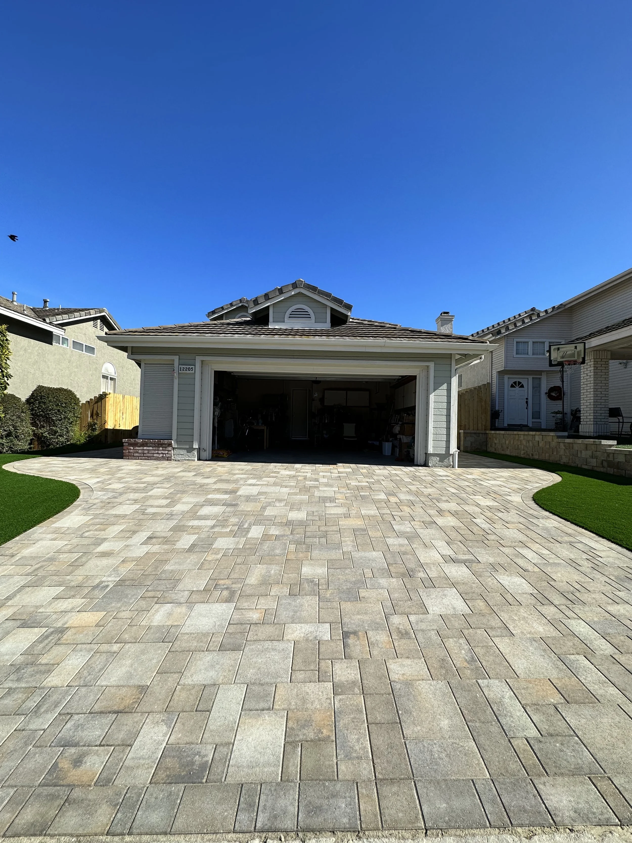 Curb appeal upgrade including paver driveway, artificial turf and retaining wall in Poway CA