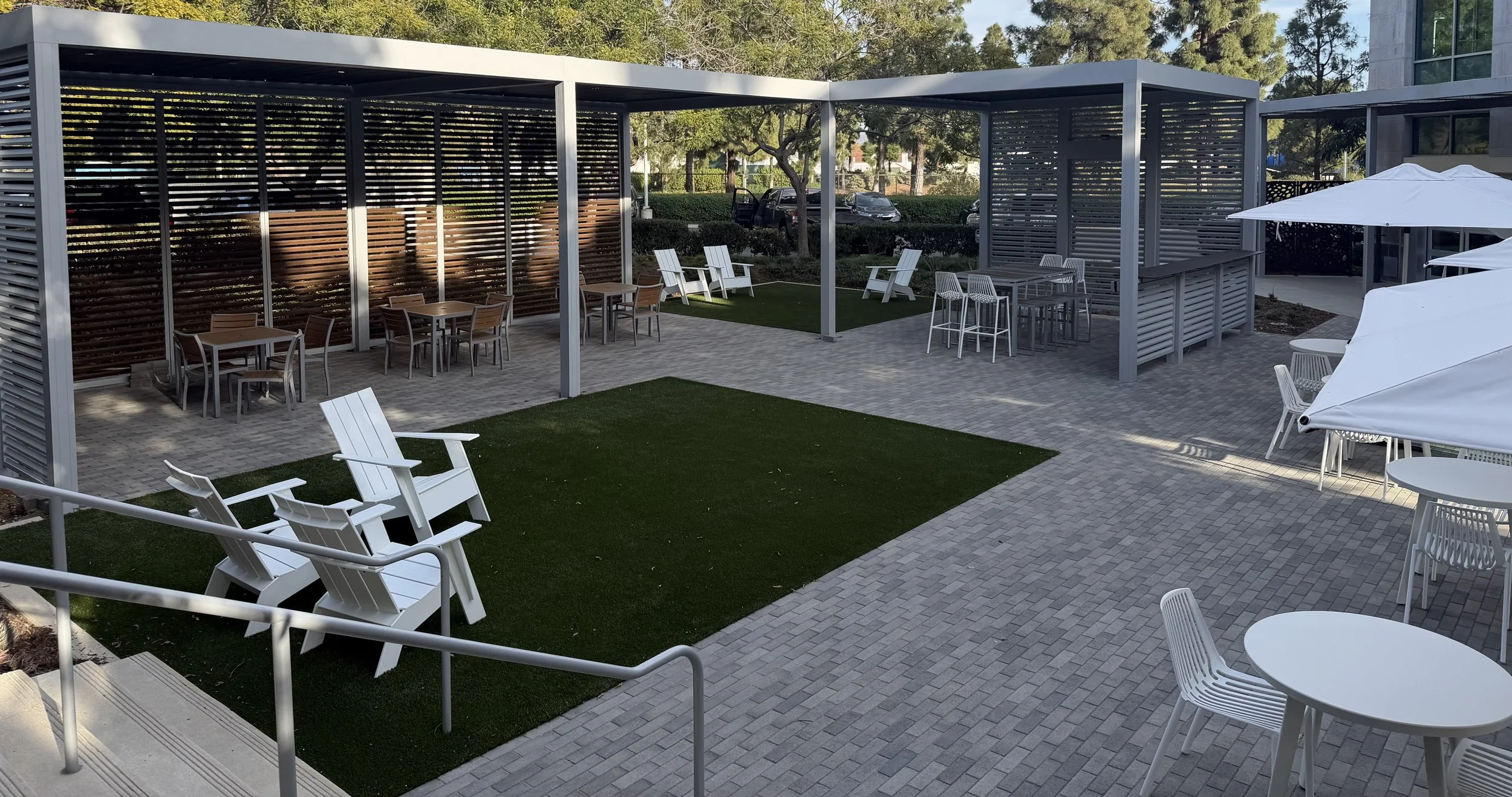 Commercial outdoor living space including paver and turf install in Carlsbad, CA
