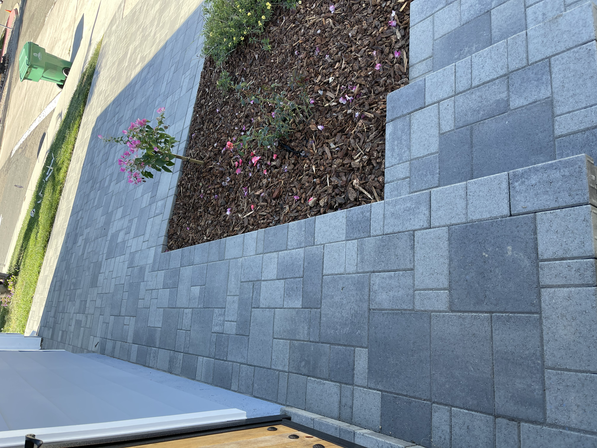 Custom paver driveway and walkway installation featuring matching steps, refreshed mulch, and clean landscape detailing for a polished front entry.