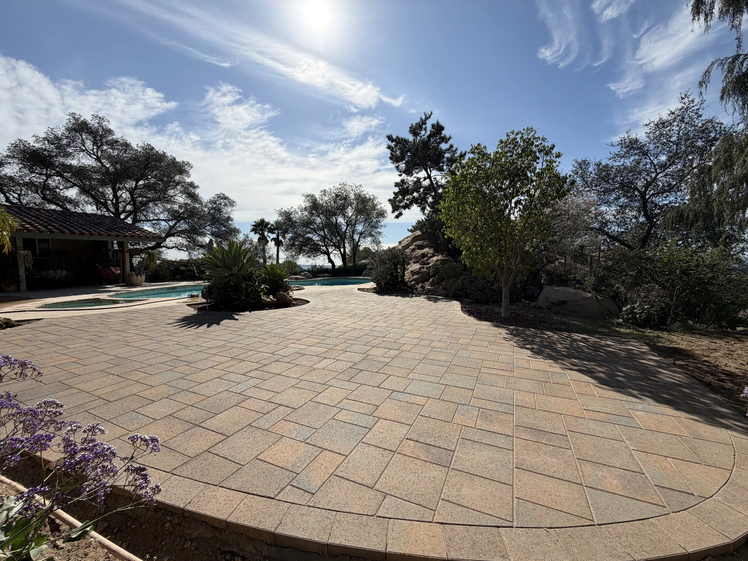 Backyard paver patio and pool deck installation