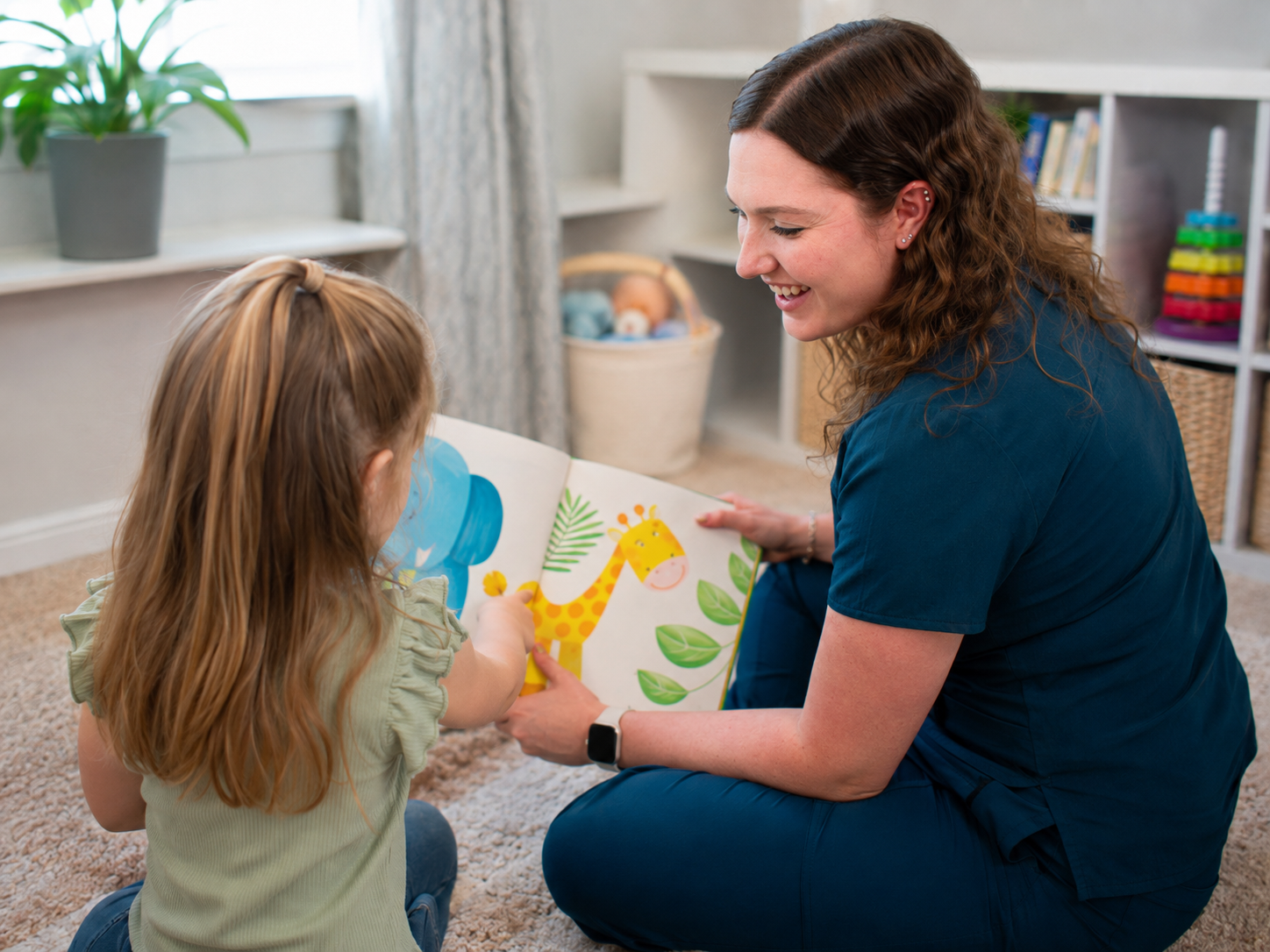speech therapist and little girl reading book during in-home speech therapy
