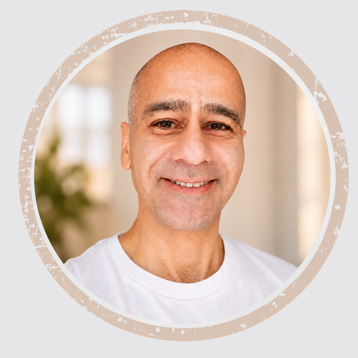 Portrait of Kevin Habibi smiling, framed in a circular opening.