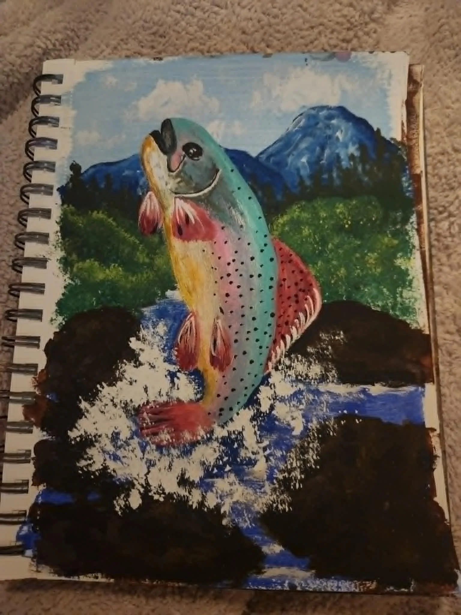 Original painting. Colorful painting of a rainbow trout fish in front of mountains and trees.