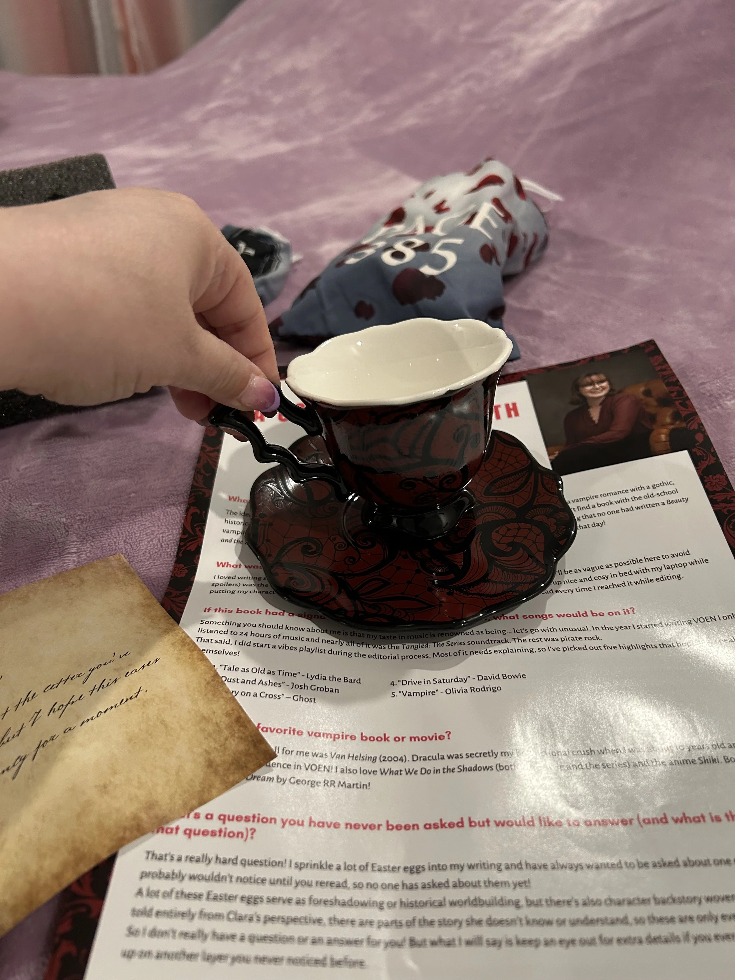 Black-and-red bat-wing teacup with matching saucer from the Beauty & the Vampire Box.