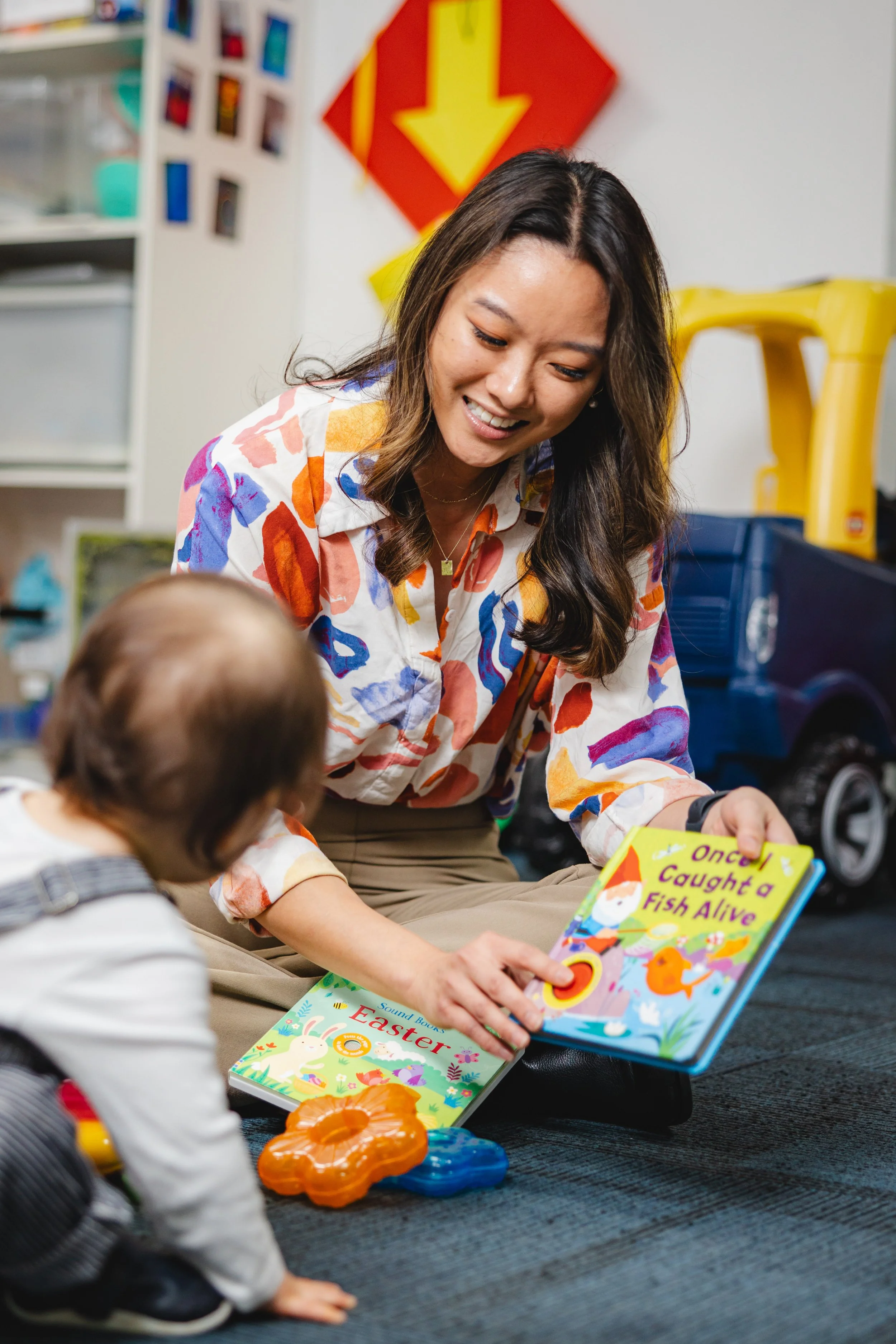 Super Kids behaviour therapist reading picture books with a young child during an ABA therapy session