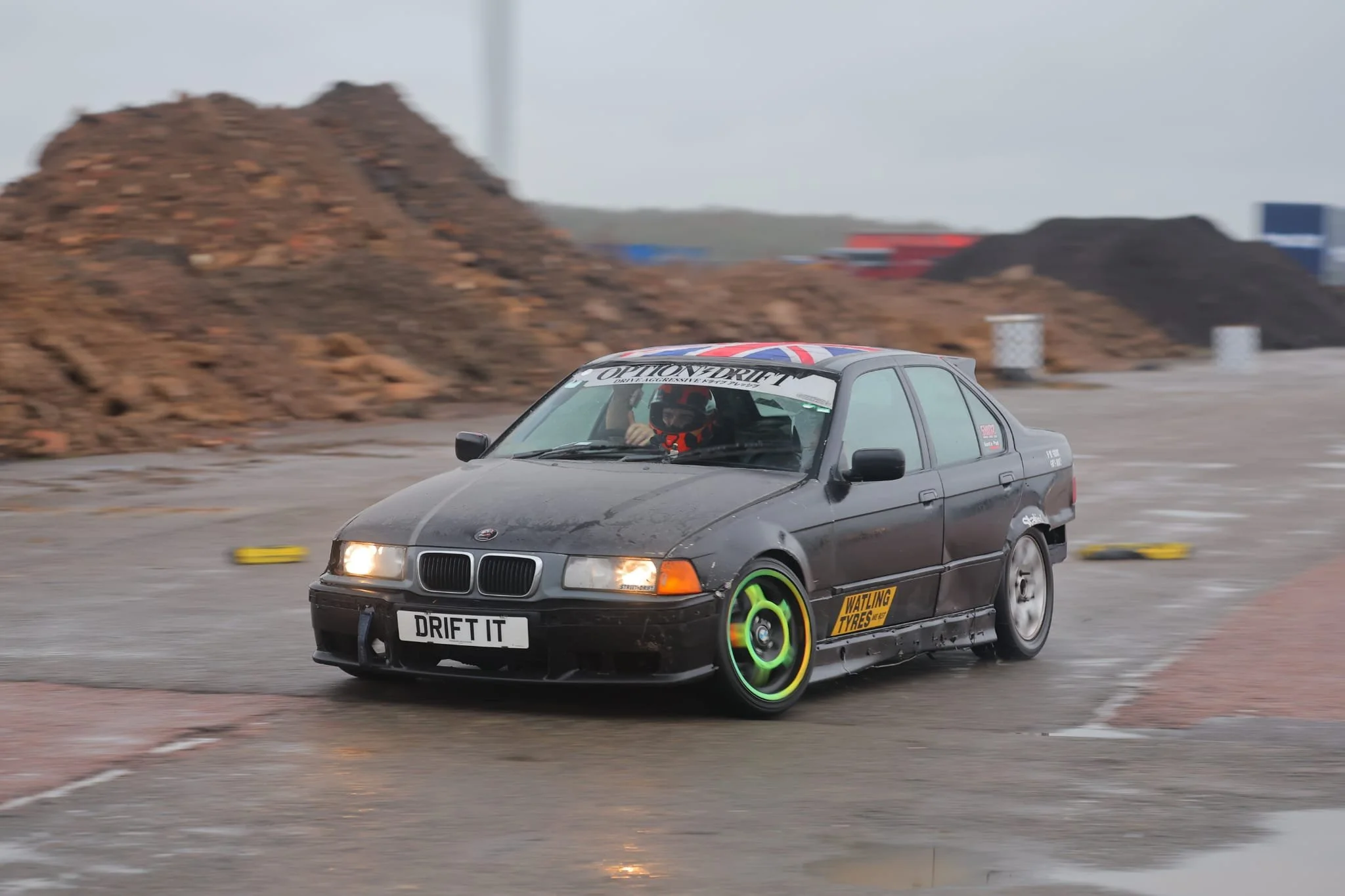 A black e36 drift car sliding on track 