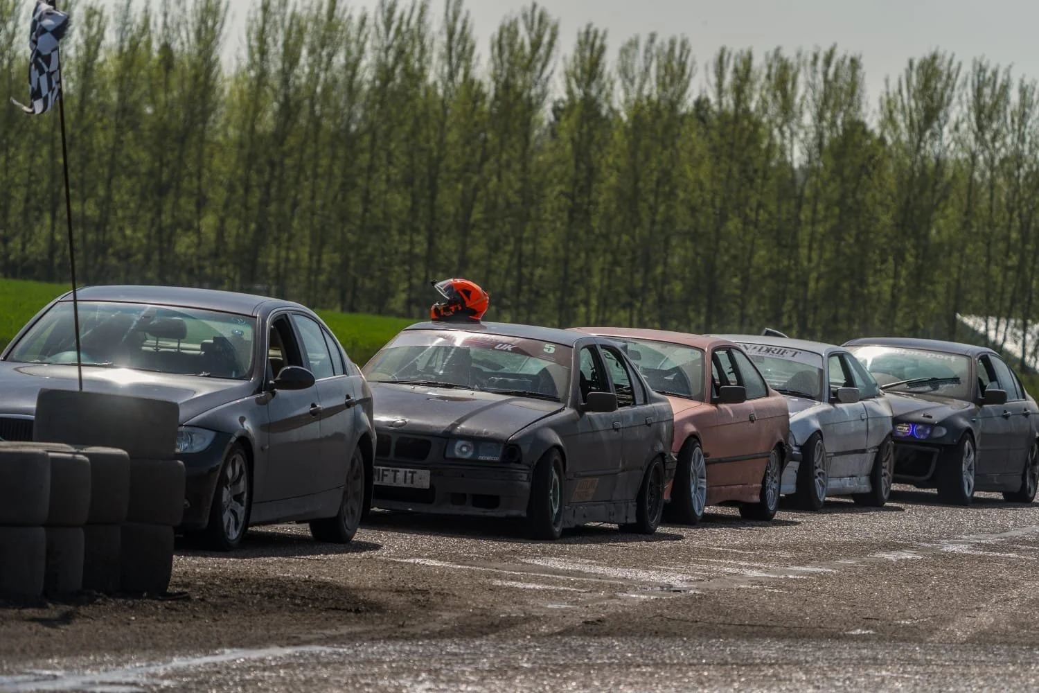 A lineup of fully prepped drift cars waiting to get on track
