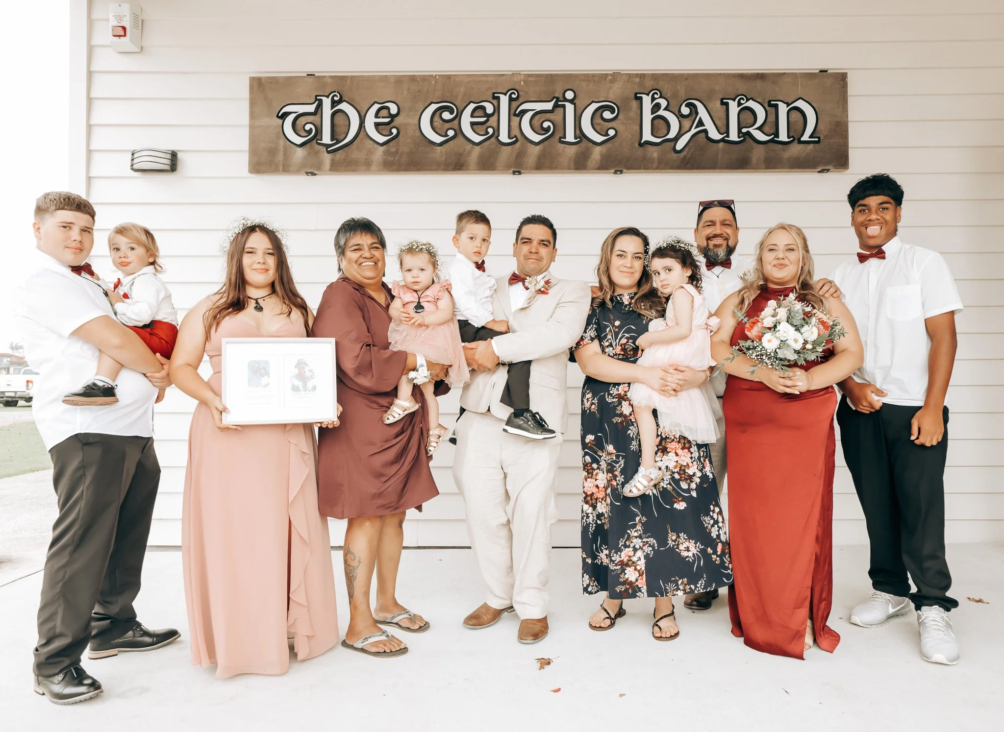 A group of people standing in front of a sign that reads 'The Celtic Barn'.