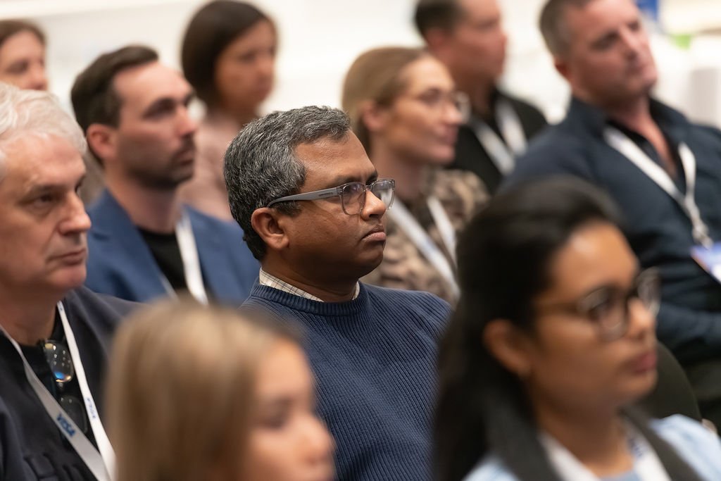 Audience attending a conference or seminar, sitting and listening attentively.