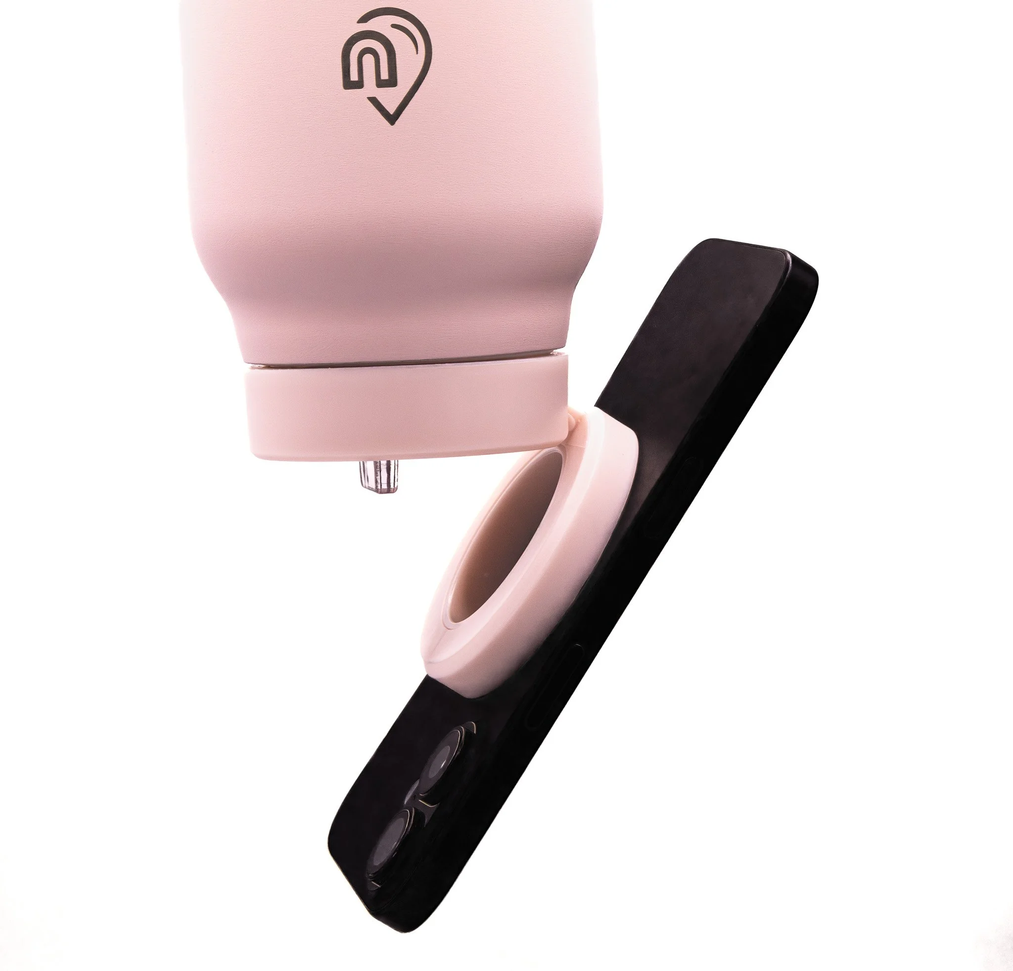 A pink electric toothbrush with a black handle and black circular power button.