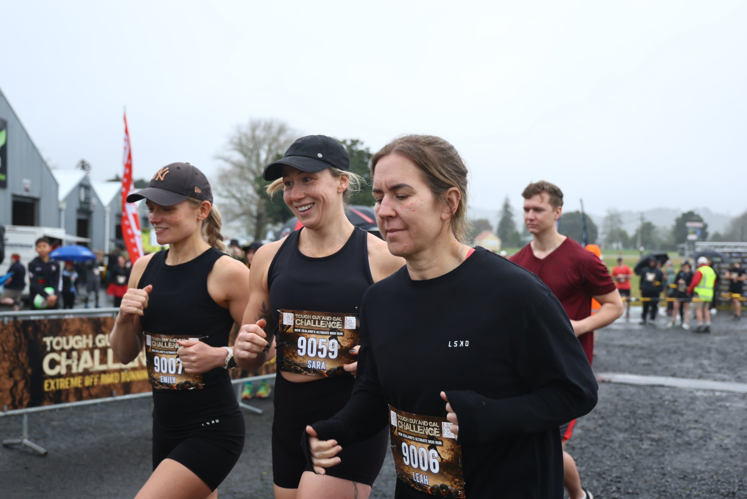 A group of runners participating in a race outdoors on a cloudy day.
