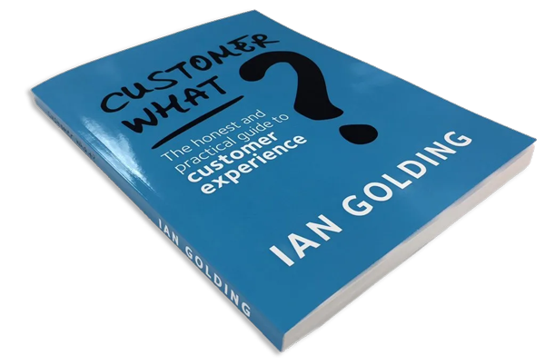 A blue hardcover book titled "Customer What?" with a large question mark on the cover. Subtitle reads "The honest and practical guide to customer experience" by Ian Golding.