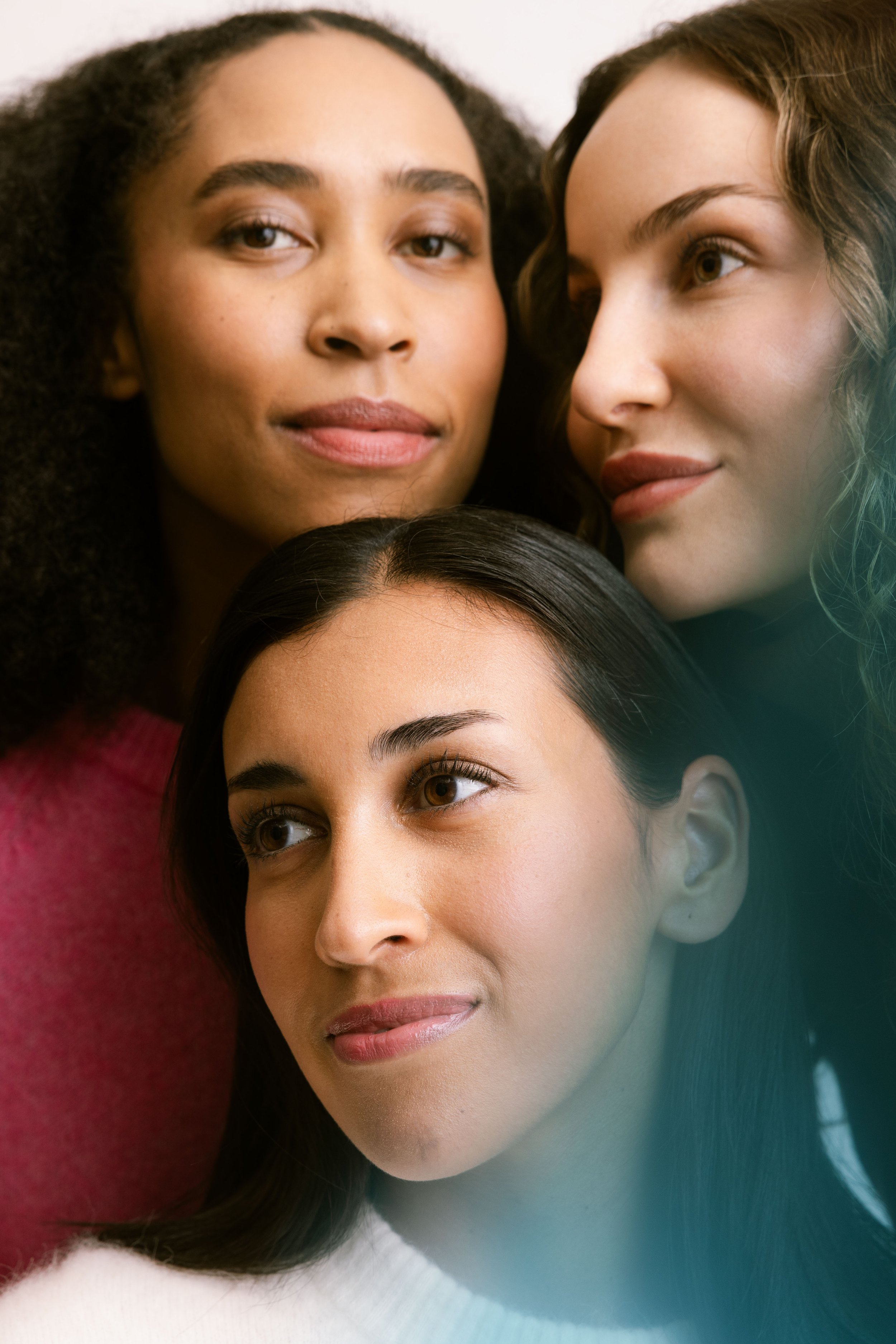Close-up of three women's faces closely positioned, with only parts of their faces visible, in a layered arrangement. Brand photgraphy for banking.