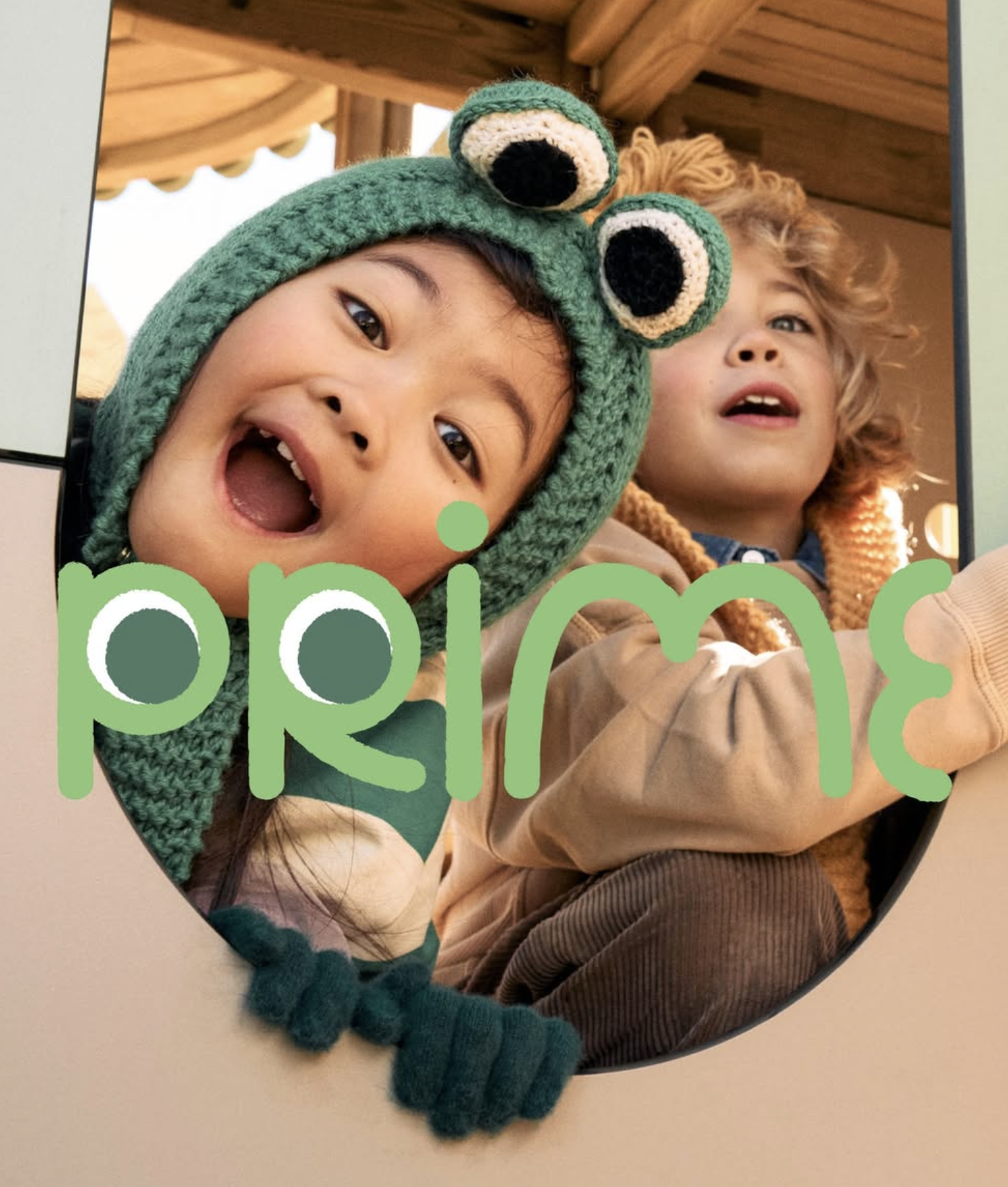 Two children smiling dressed as a frog and a lion. Ad photo for Lappset Prime playgrounds.