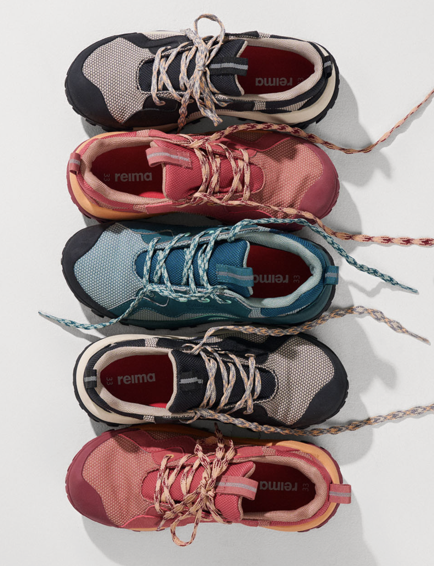 Colorful athletic shoes arranged in a row on a white surface.