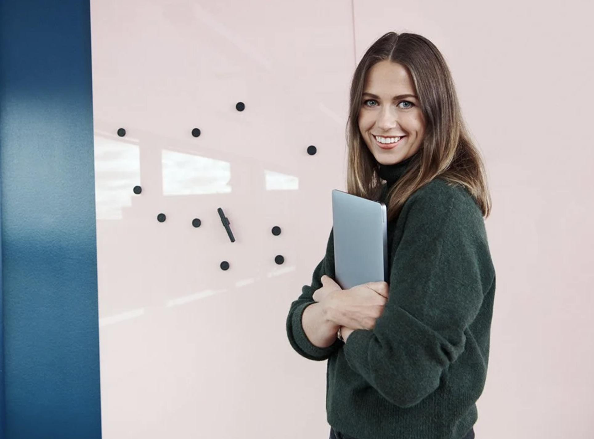 woman smiling for camera at an office. brand photography