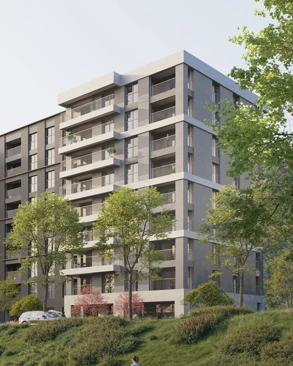Un edificio residenziale moderno con balconi, circondato da alberi e vegetazione nel verde.