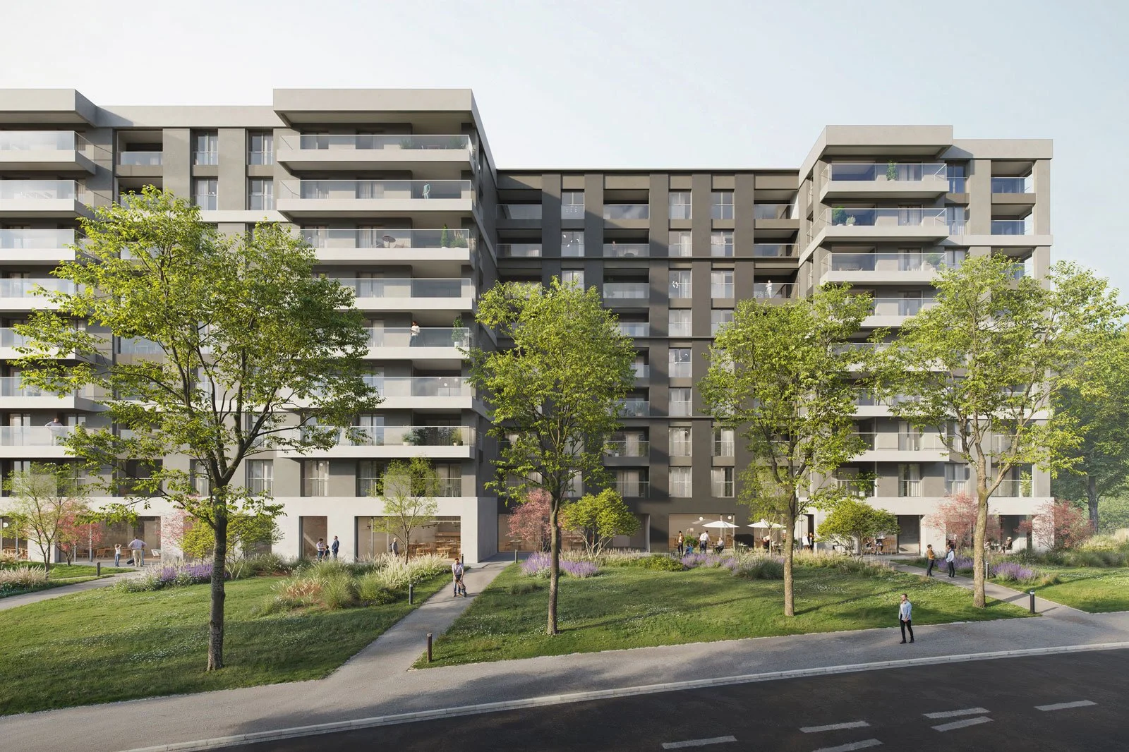 Edificio residenziale moderno con balconi e giardini frontali, alberi e persone che passeggiano lungo un viale in un parco urbano.