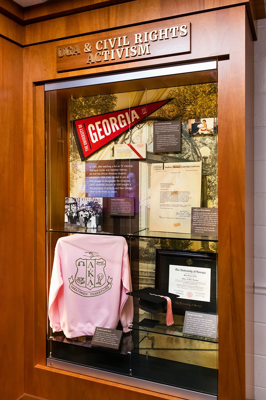 The display case highlighting Early's civil rights activism features memorabilia from her time at UGA, including a pennant, her graduation cap, and diploma.