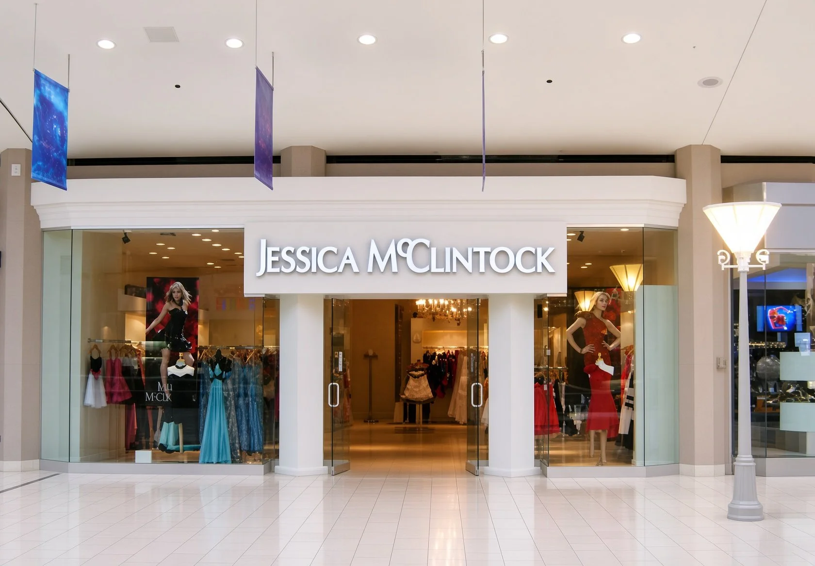 Jessica McClintock store front with mannequins dressed in evening gowns, and the store sign above the entrance.