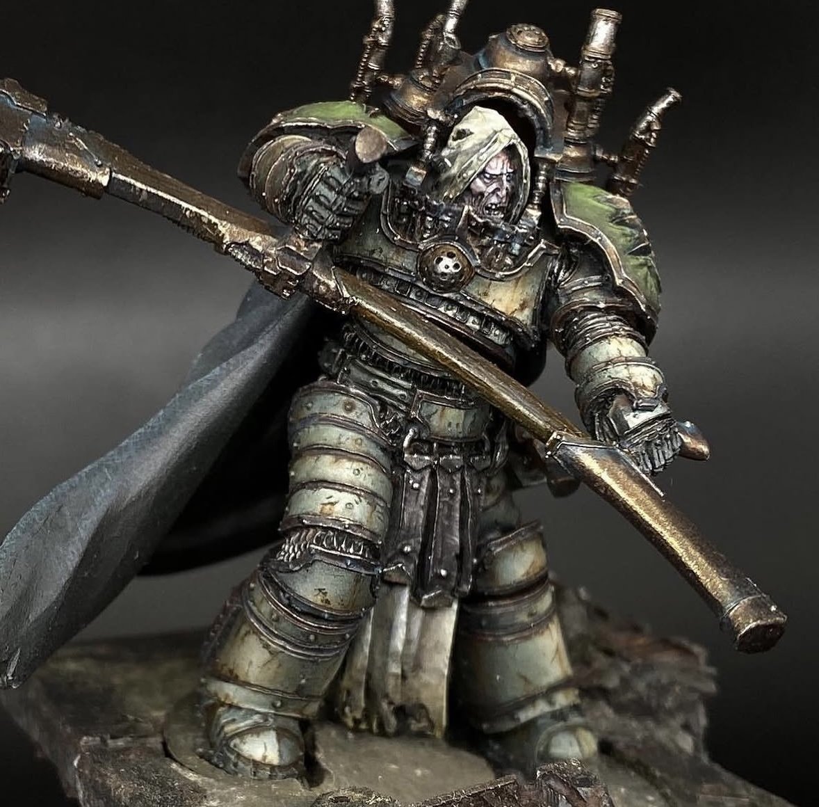 A detailed miniature figurine of a science fiction soldier in armor NAMED MORTARION, PRIMARCH OF THE DEATH GUARD, holding a long weapon, with a grim expression, and a rugged terrain base.