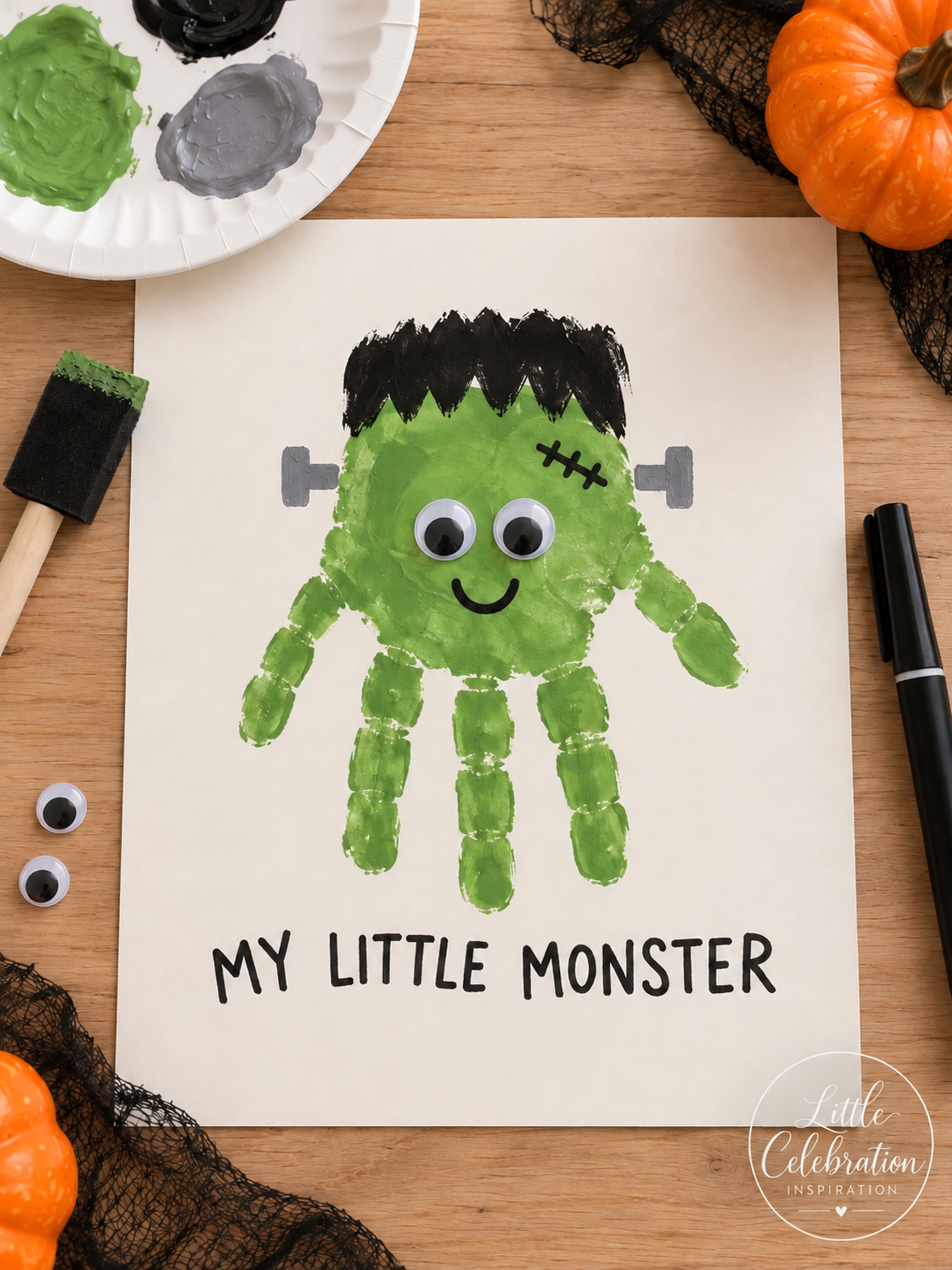Green child handprint transformed into a friendly Frankenstein monster with googly eyes.