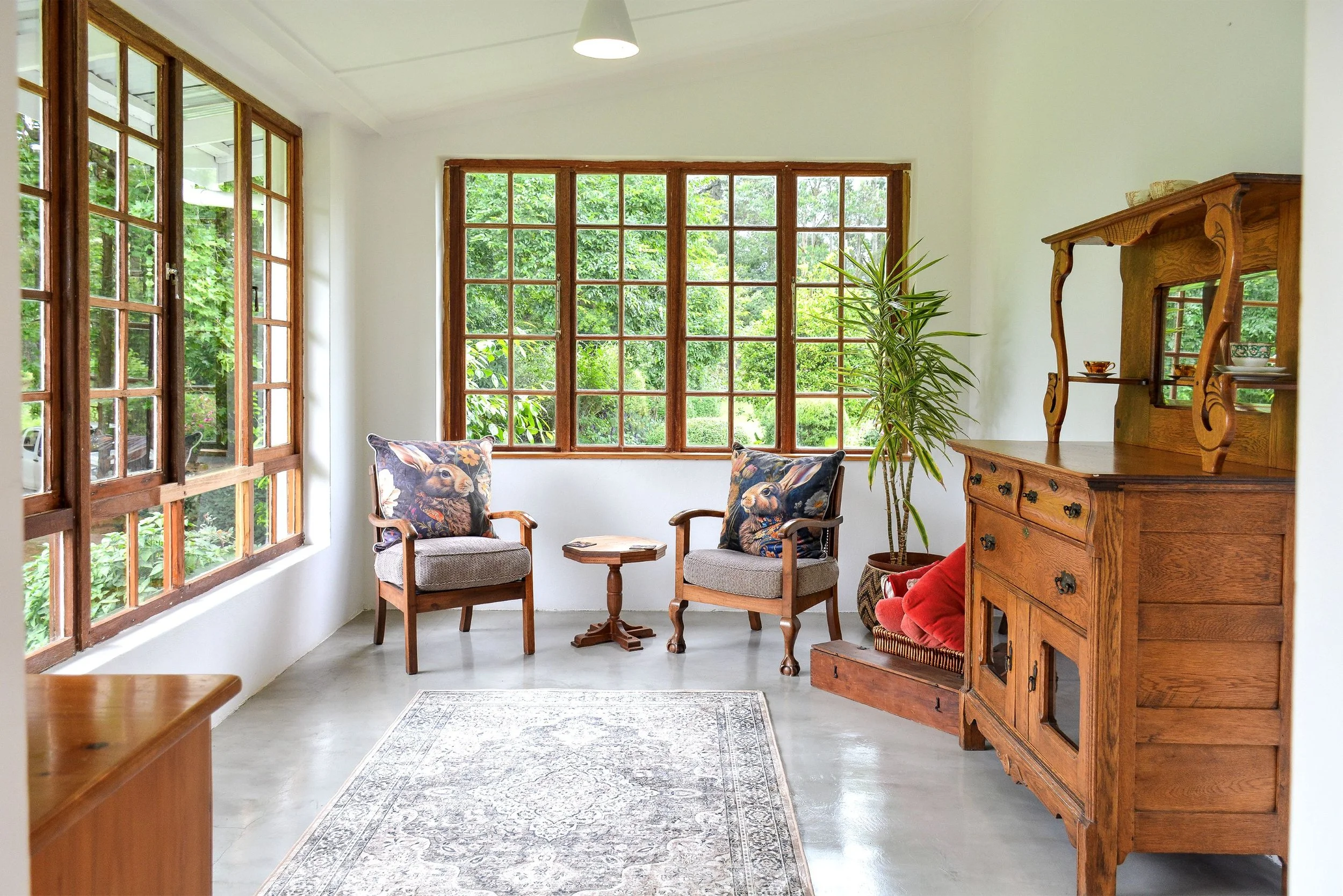 Cosy sunroom at the accommodation overlooking the garden.