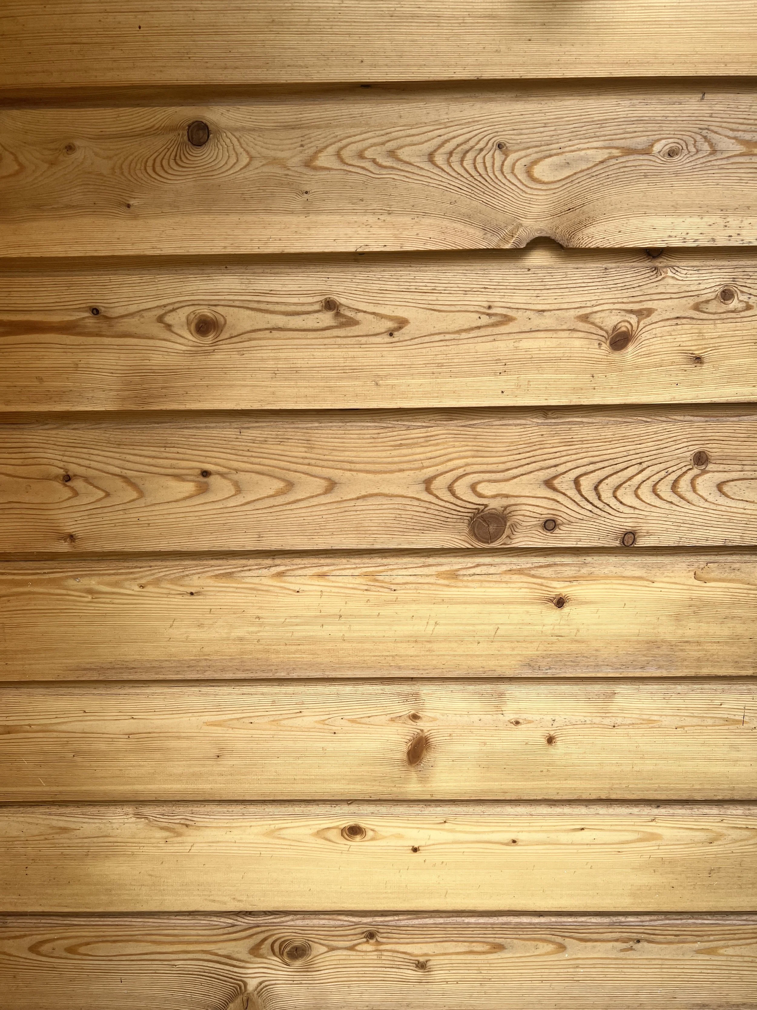 Close-up of wooden horizontal planks with visible wood grain and knots.