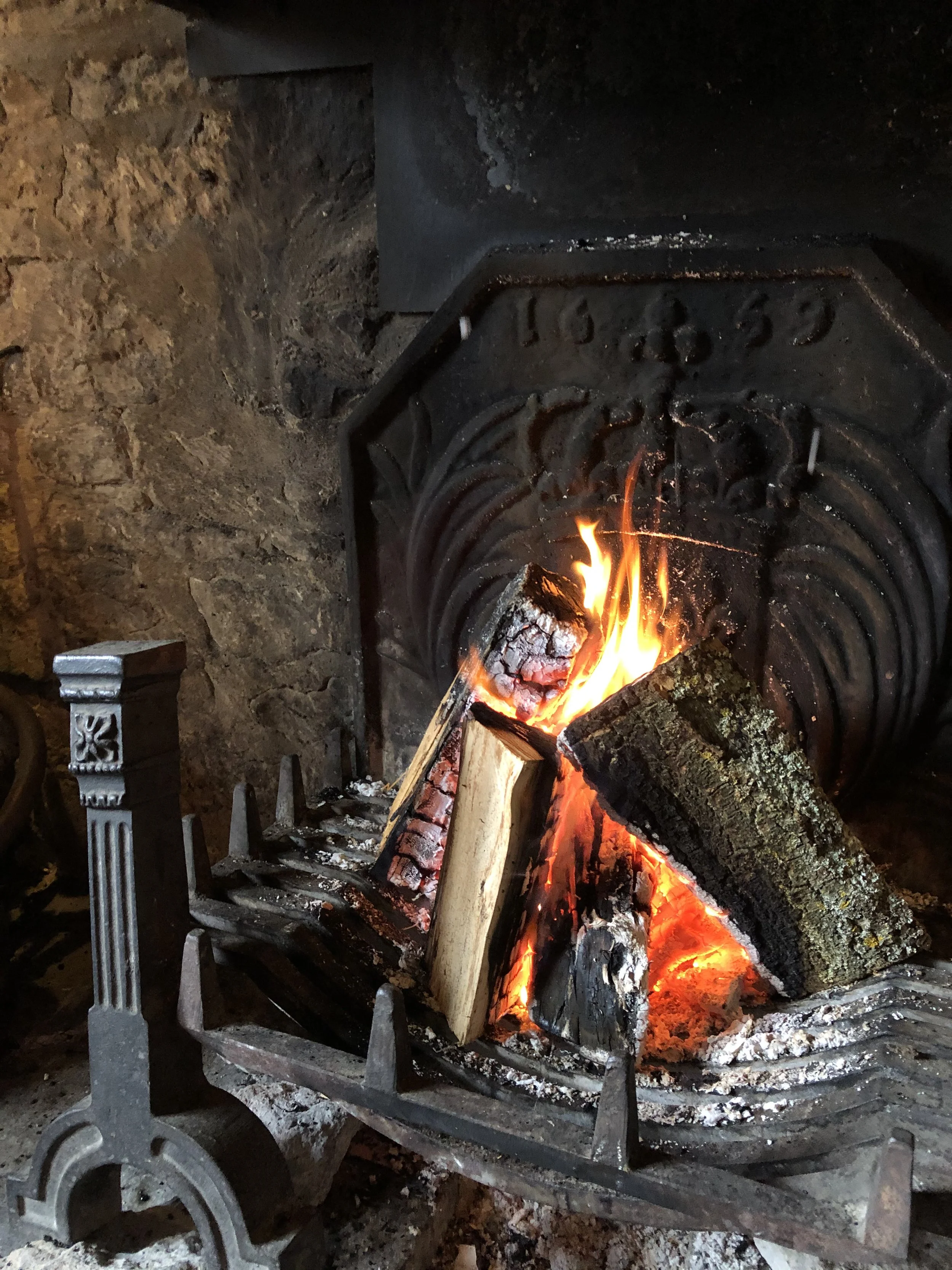 Fire burning logs in a stone fireplace.