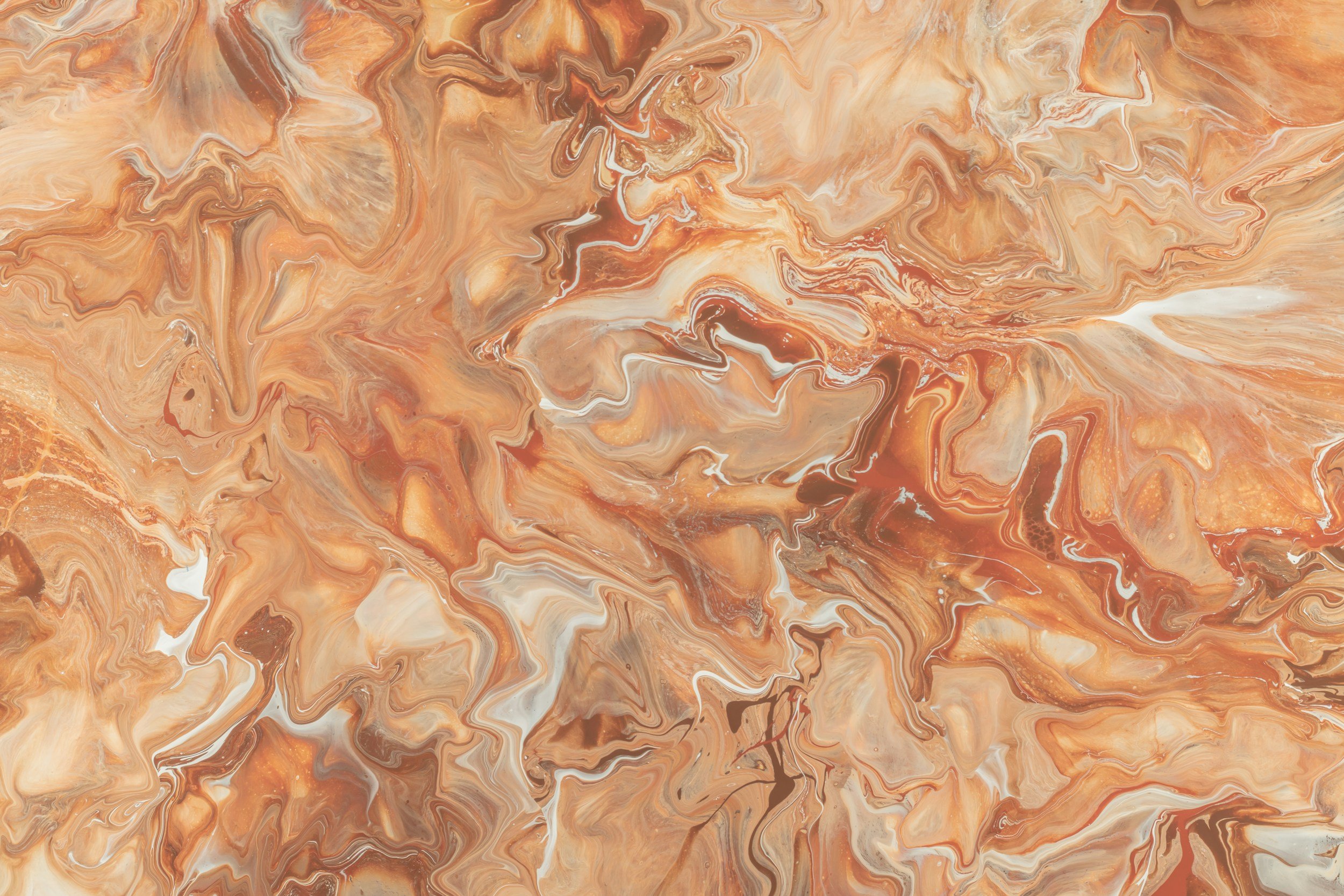 Abstract swirling patterns in shades of orange, brown, cream, and white resembling marble or liquid paint.