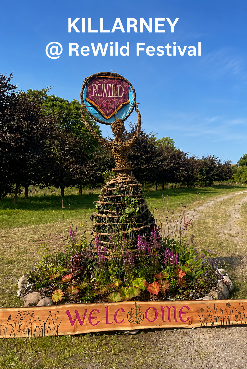 Rewild Festival entrance installation featuring an imposing woven willow goddess holding a moon, surrounded by wild plants