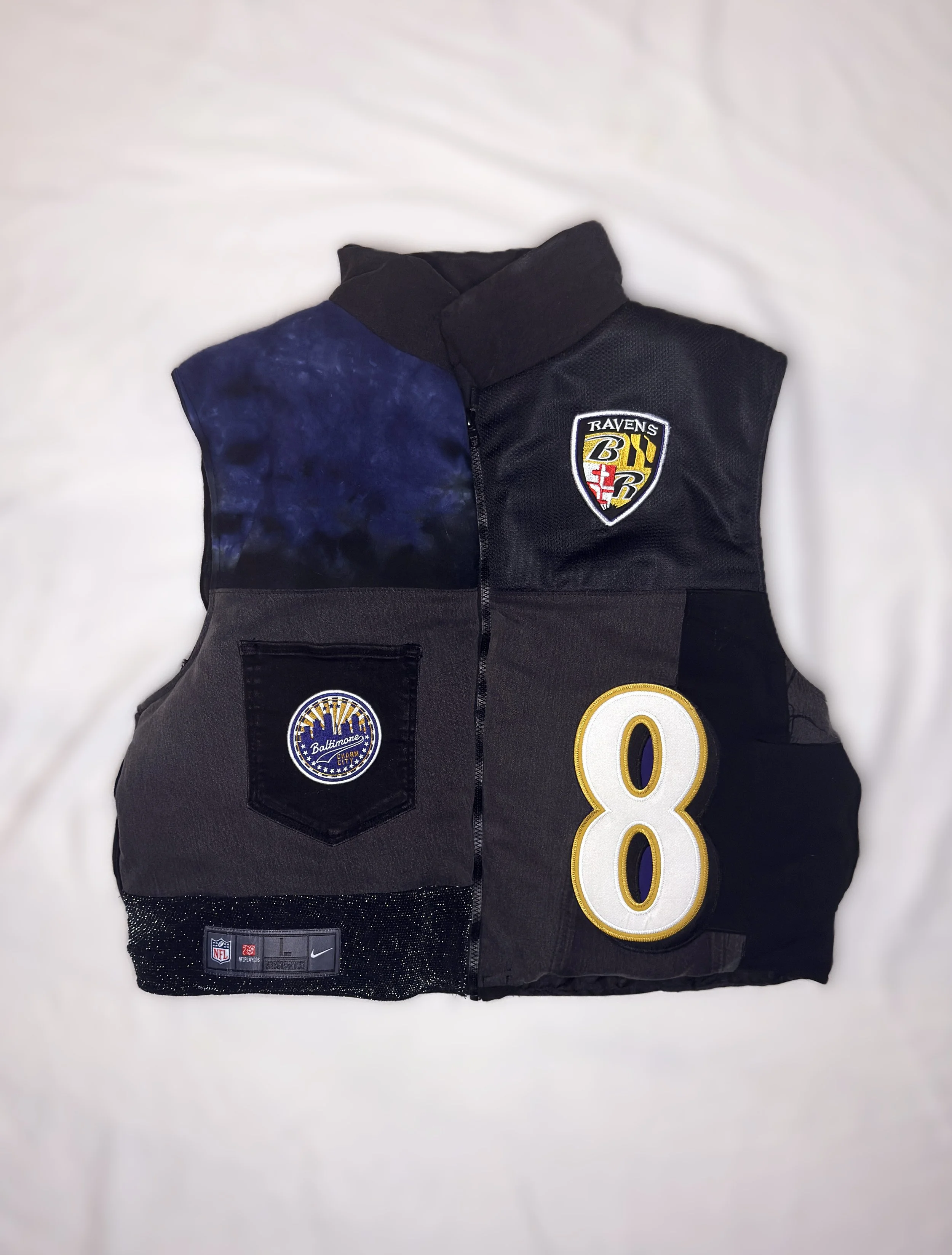 A Baltimore Ravens NFL football jersey with the number 8, a team patch on the chest, and logos on the bottom portion.