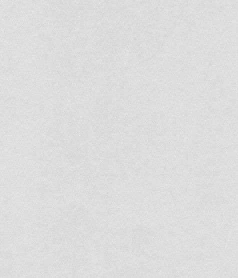 A close-up photograph of a black textured surface, possibly a fabric or a material like asphalt or rubber.