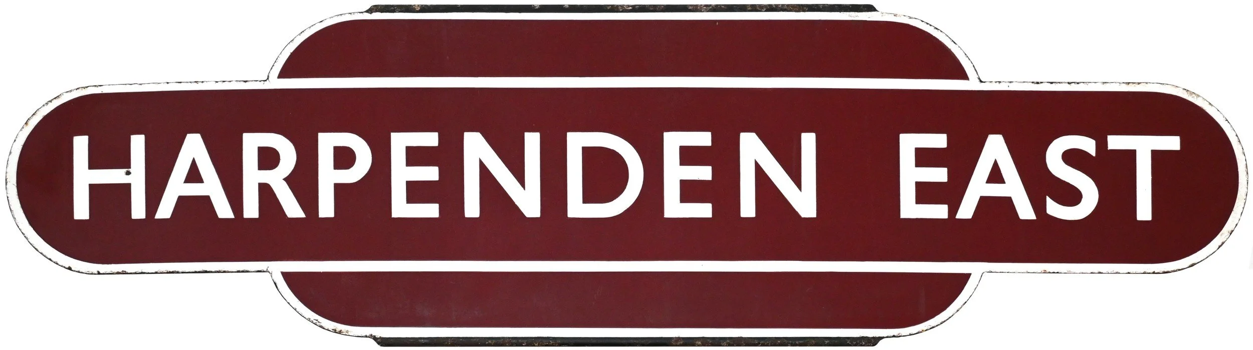 A railway station Totem with a dark red background and white text that reads "HARPENDEN EAST."