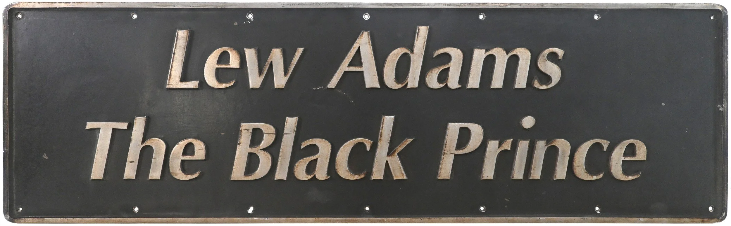 locomotive nameplate "Lew Adams The Black Prince" on a dark background.
